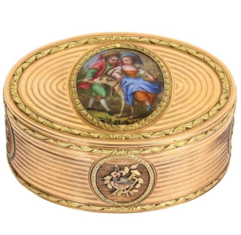 Three-tone gold oval enamel snuff box with with repoussé gold work of musical instruments
Enamel plaque center
Circa late 18th century - early 19th century, Switzerland
Weight: 76.5g
Dimensions: Approximately length: 2.59 in, width: 1.81 in, height: