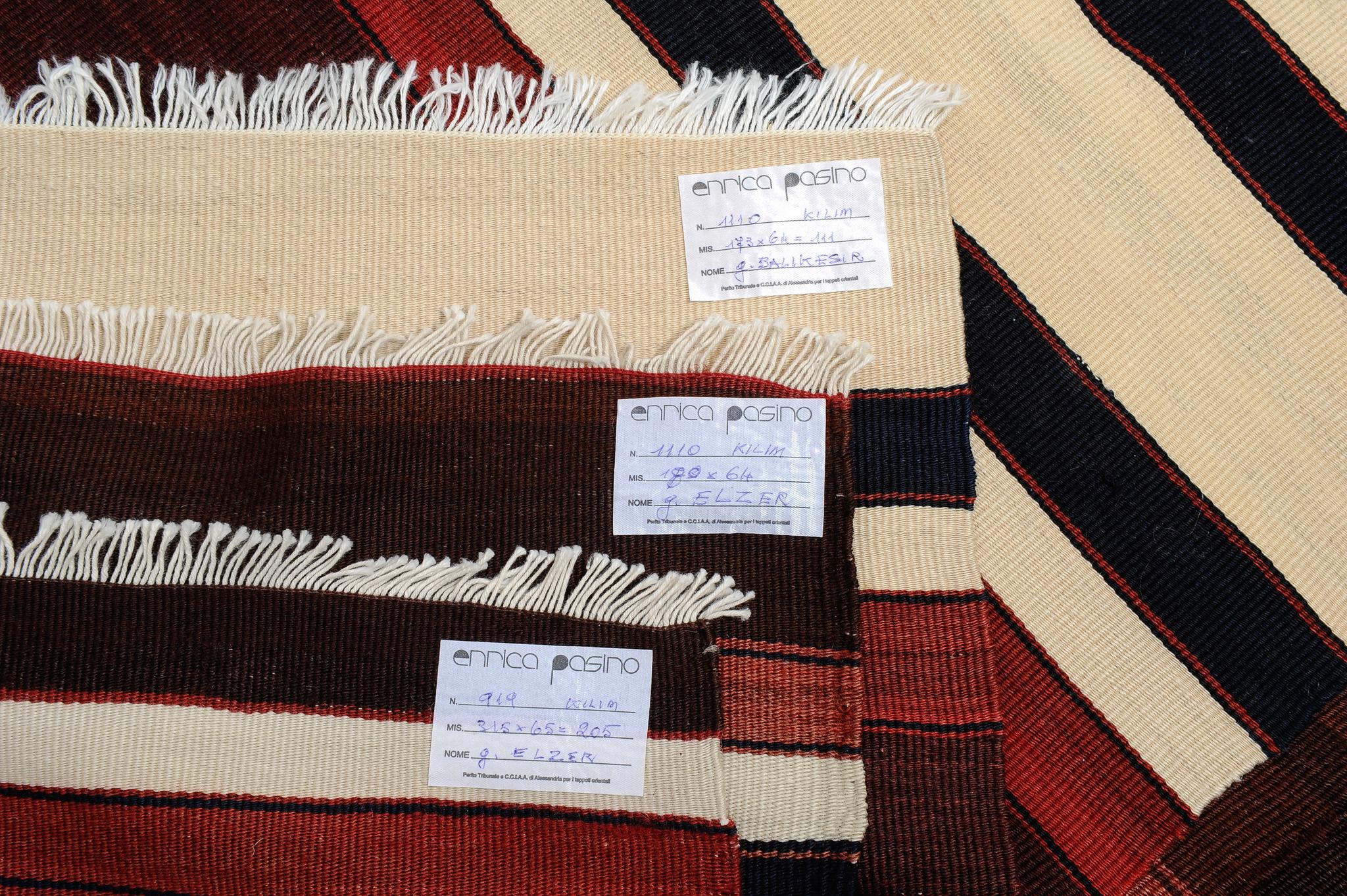 nr. 1110 - Three Turkish kilim strips for any use: perfect for kitchen and bathroom.  Sizes: cm.180x65 - 173x65 - 315x65. 
Ivory-white stripes, the natural color of wool, with brown and dull red, for these simple and modern look vintage kilims.
You