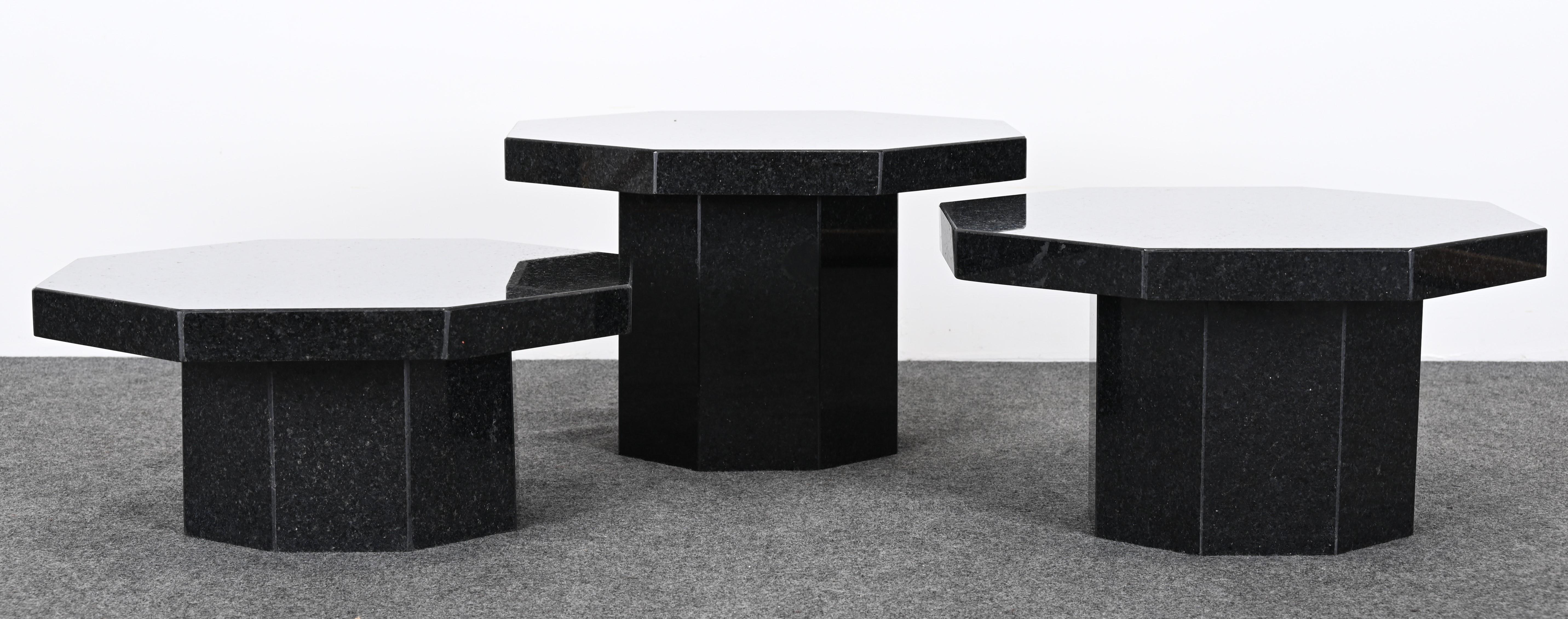 A modern set of three Up & Up Graduating Octagonal Black Granite Tables. Would look stunning in a modern or contemporary setting. They can be used in a grouping as shown in images. Also, can be used as various occasional tables. One has a minor chip