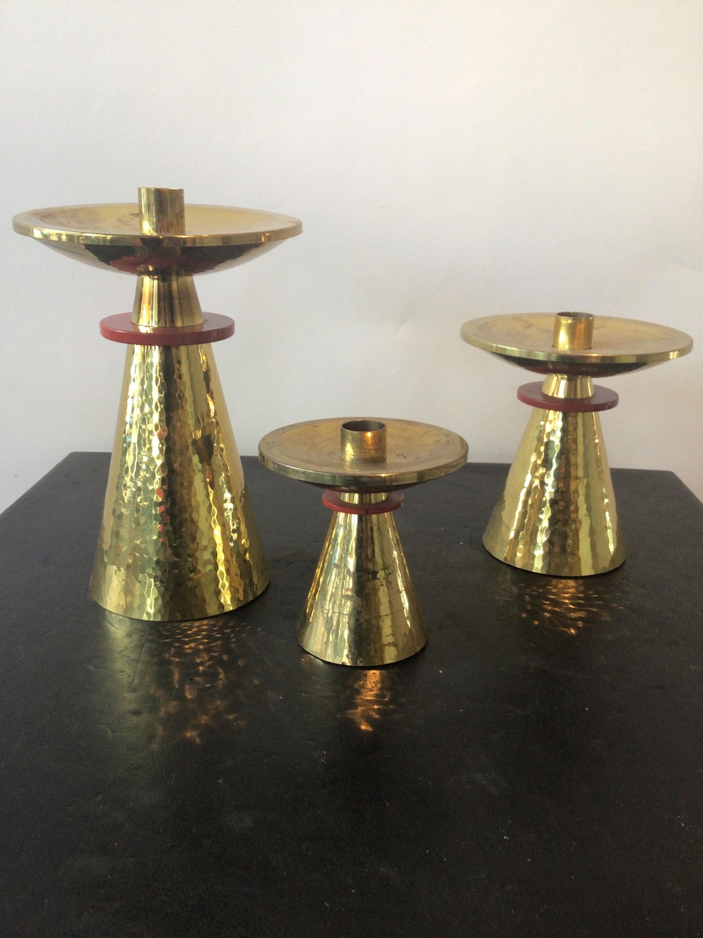 3 varied height hand hammered brass candlesticks. Made in Switzerland in 1964.