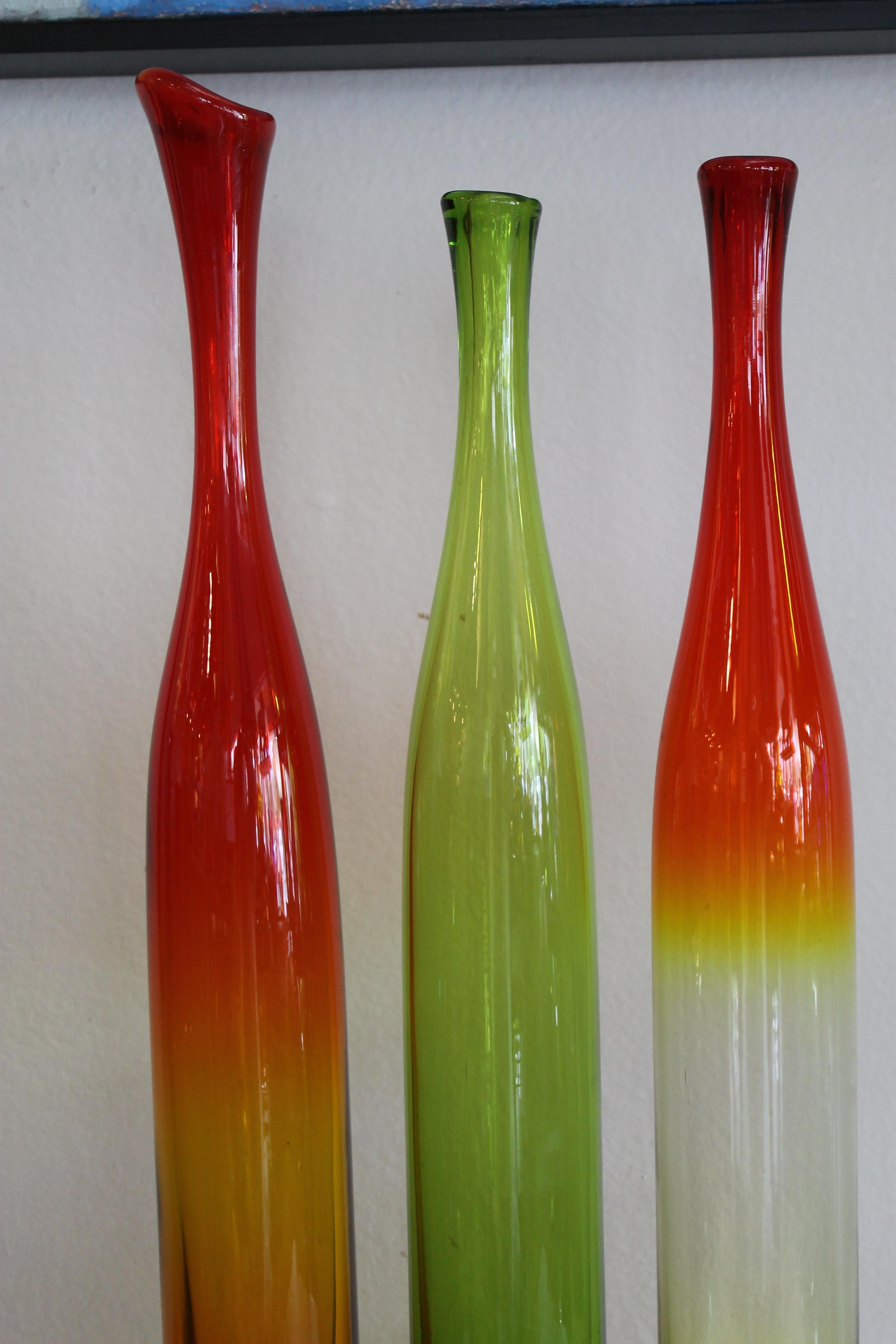 Three Joel Myers colored glass vases, model no. 6427, 1960s. Manufactured by Blenko. The tallest vase is 23.5
