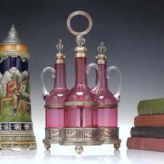 Three Victorian Glass Cranberry Claret Jugs / Decanters in Silver Plated Frame