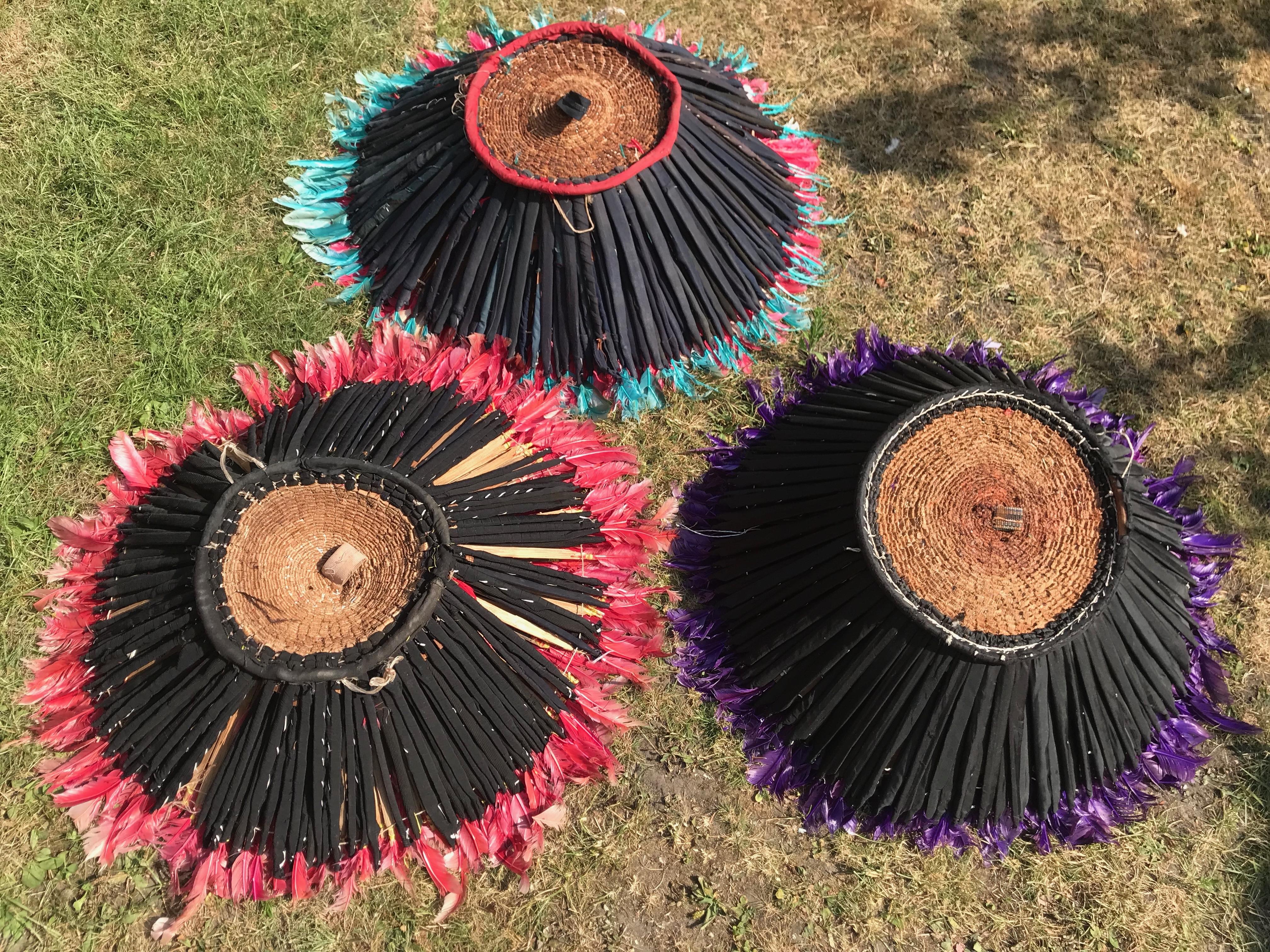 The hat itself is constructed from raffia which is woven by hand to create the support structure. A strap attached to the back is used to pull the hat open to its full breadth. These headdresses are stunning as contemporary wall hangings.Made in the