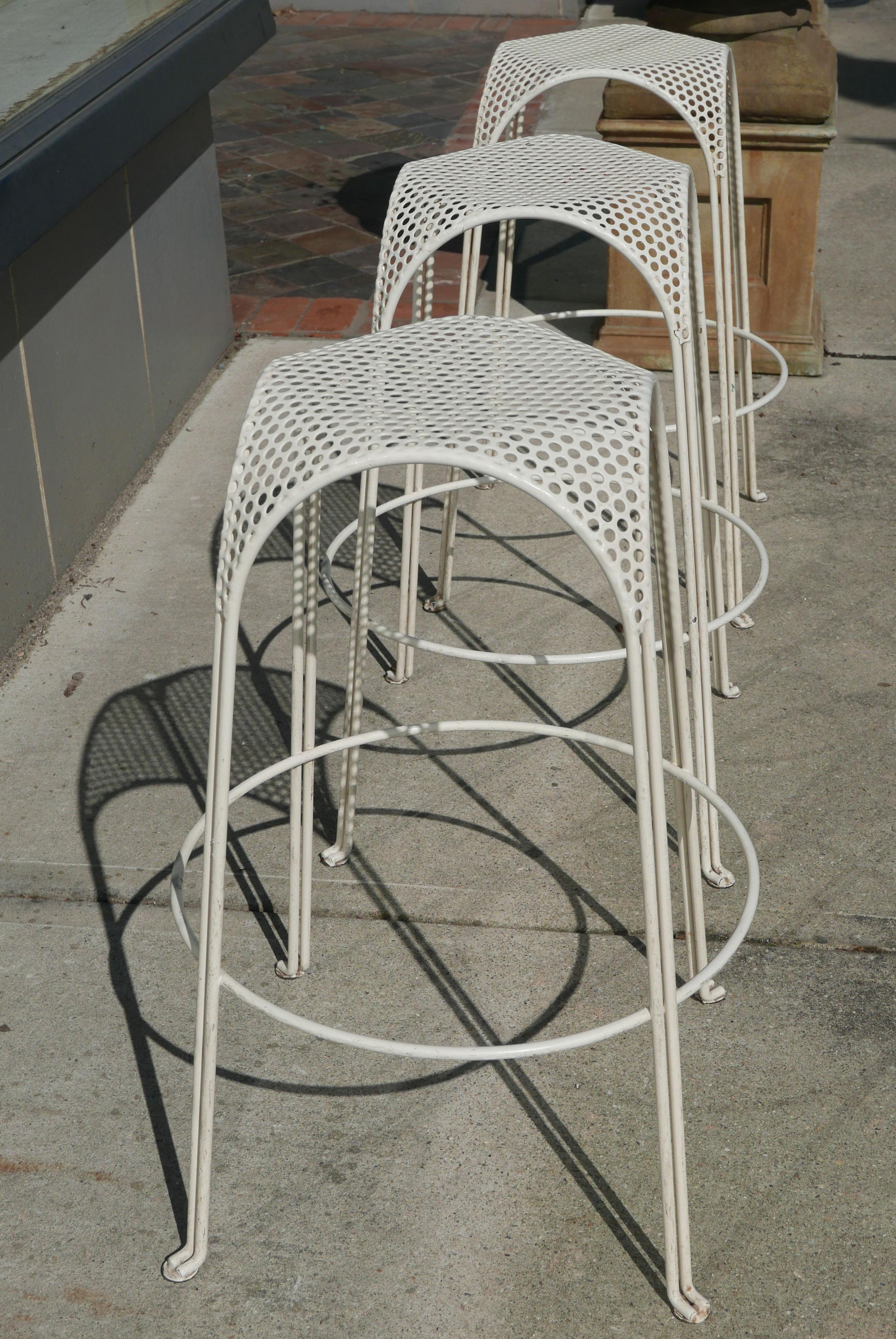 Three vintage bar stools in the manner of Mathieu Matégot done in white and probably made in the early 1980s. Seat size is roughly 11.5