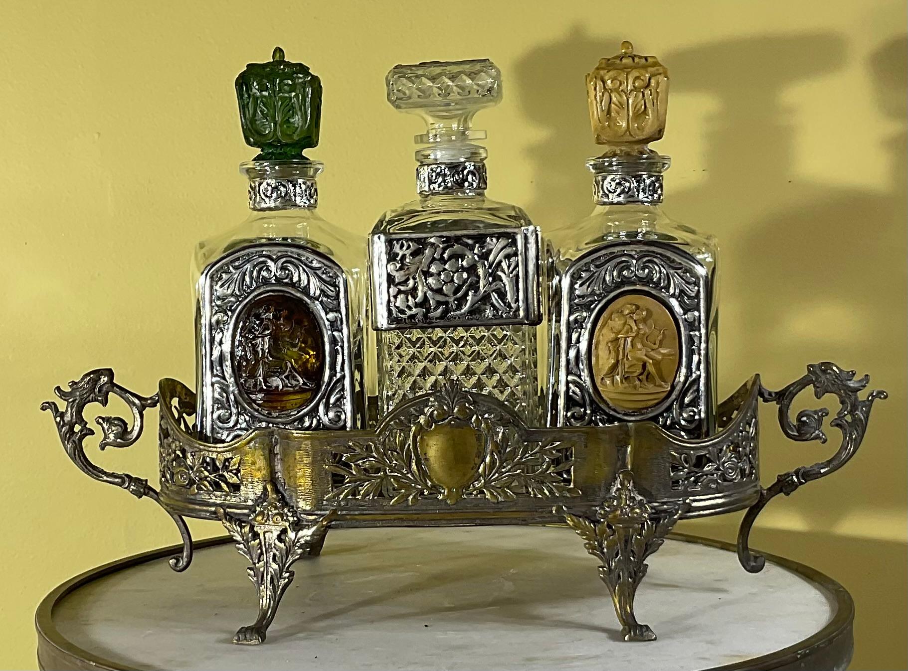 Beautiful and special set of silver plate tray with three crystal glass bottle decanters . Two bottles provides with resin made top and splendid cameo in the Center , all bottles have intricate 925 sliver sterling Ornate Design .
signed by