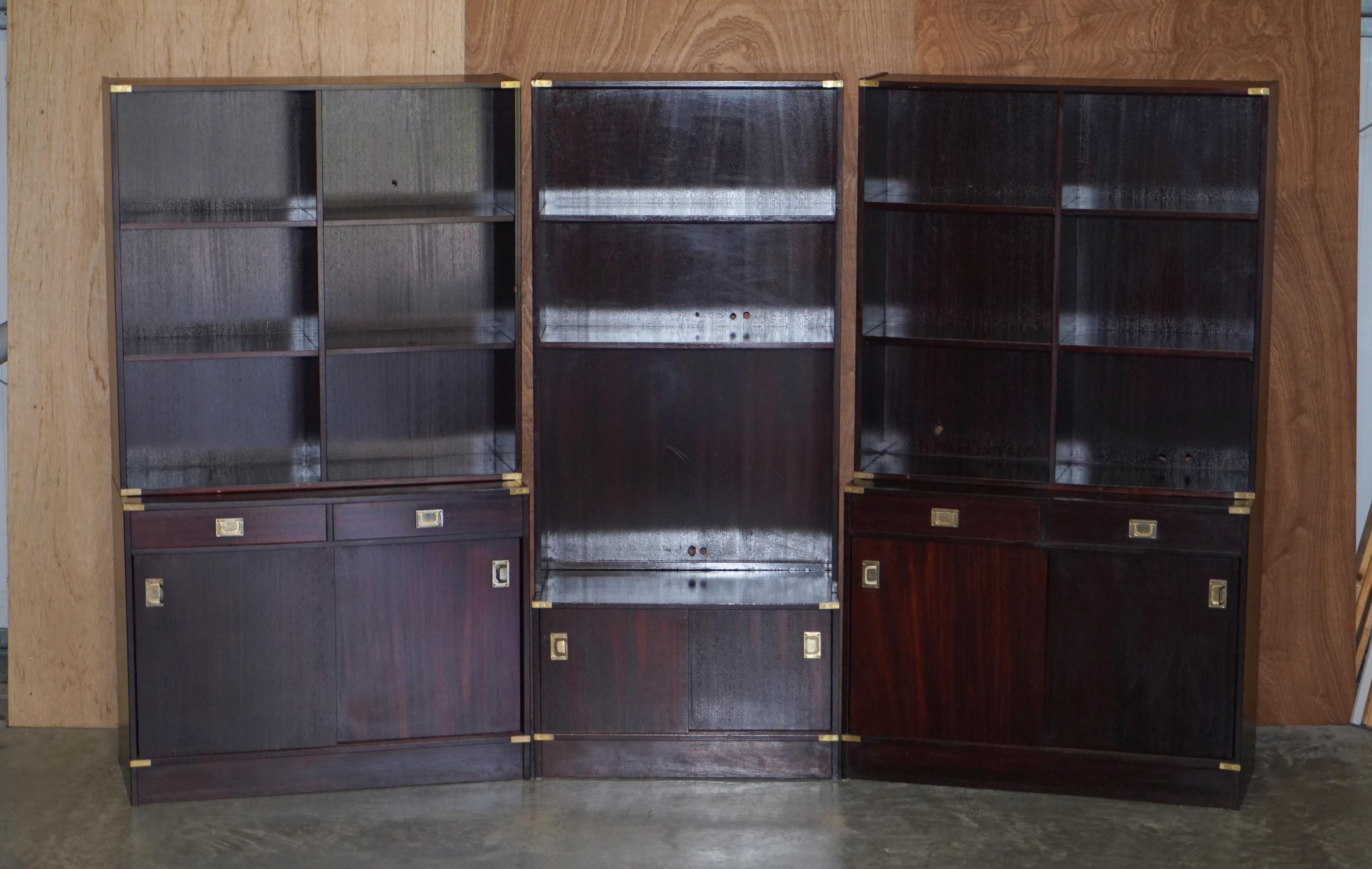 We are delighted to offer for sale this suite of three mahogany finish Military Campaign style bookcases used as media storage

A good looking and unitarian suite of bookcases, they are all finished on the sides so can be used as single