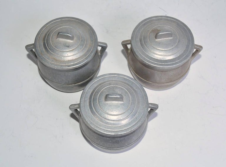 The vintage pewter pot de crèmes could also be used for soups or other hot liquids. The lids have undecipherable stamps.