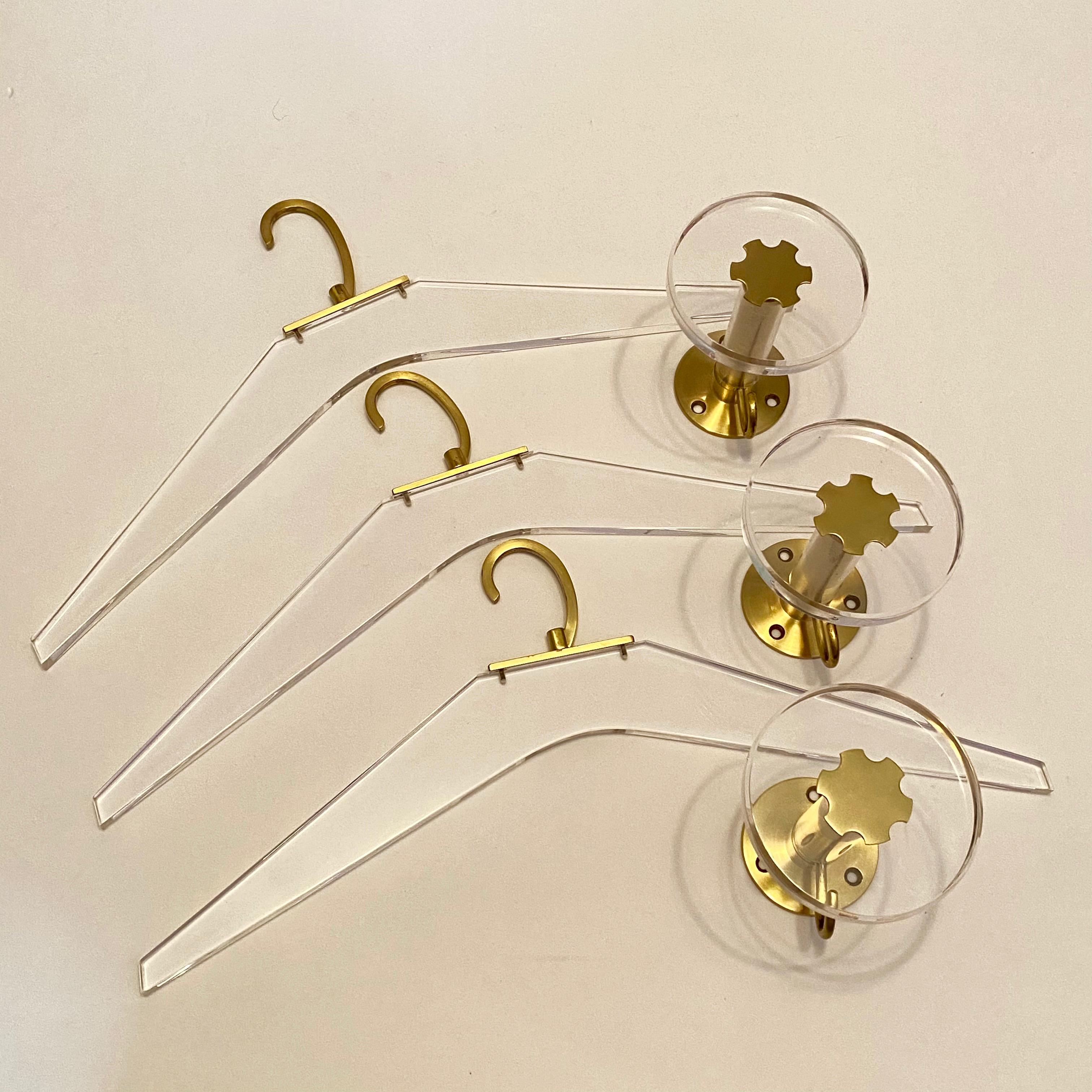 Lot of three coat hooks and cloth hanger, 1970s German. Nice addition to your room, entry hall or just for your collection of design items. Made of brass and Lucite. They are in used condition, with minor scratches and a nice patina. Coat hooks