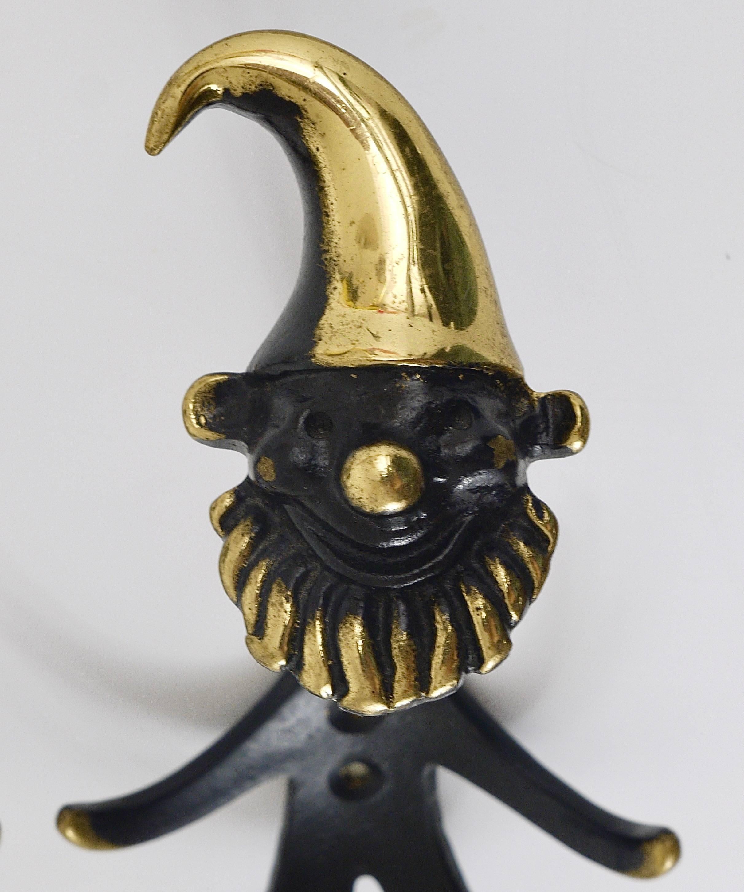 Up to three midcentury brass wall coat hooks, displaying a dwarf. A humorous design by Walter Bosse, executed by Hertha Baller Austria in the 1950s. Made of black finished brass. In very good condition. Each hook has a height of 7