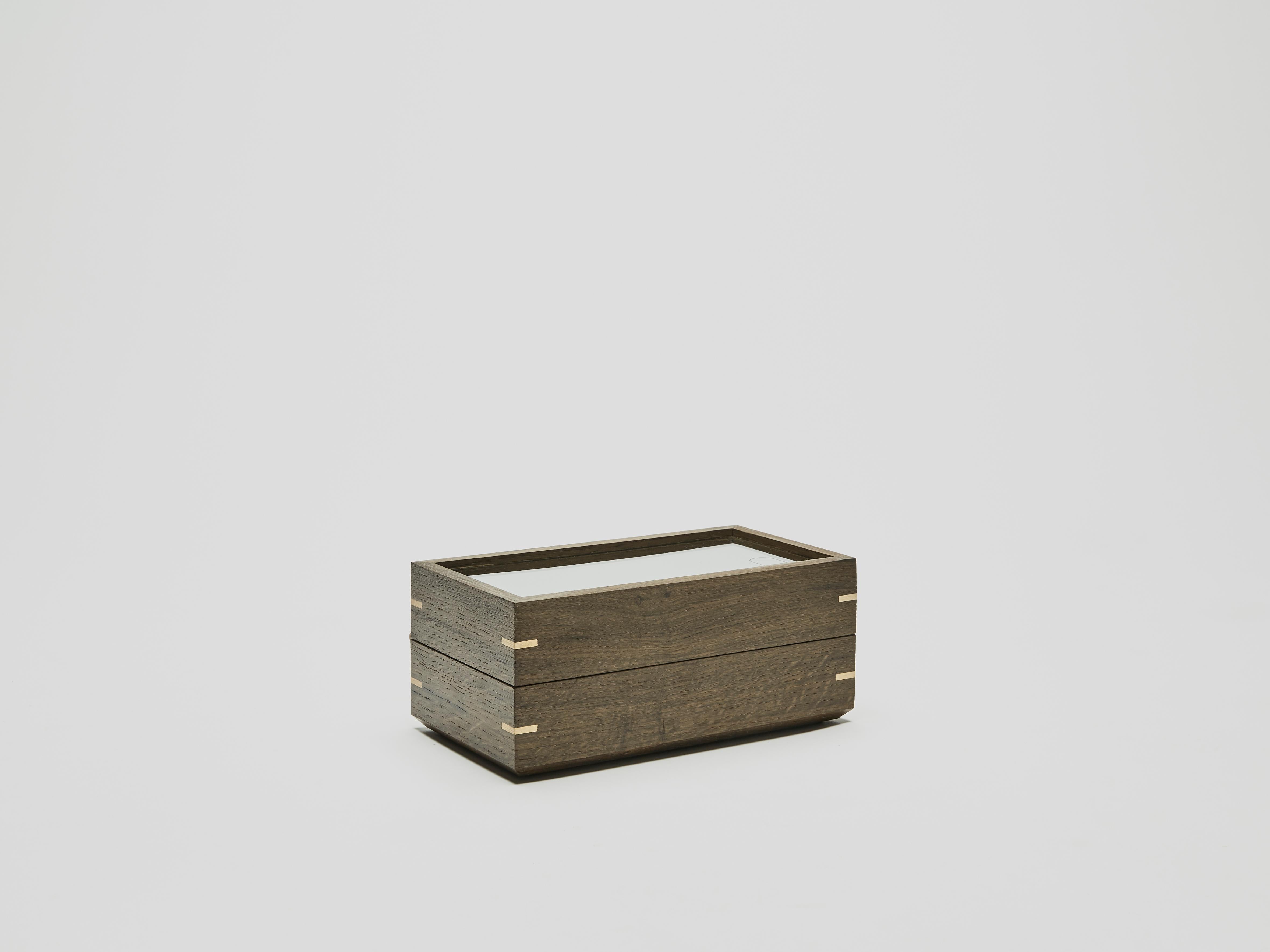 Dovedale — has created three different sized watch boxes.
Collection Nr3, three watch box made from hardened glass and a solid bog-oak wood frame. Detailed with brass finger joints and hinges. Each product houses, three watches at a time. They have