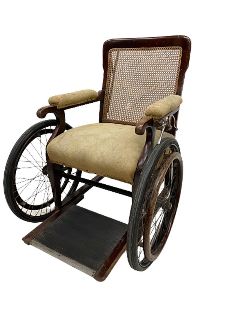 Three wheeler invalid chair by John Carter, London, 1890s
A mahogany self propelling wheelchair with adjustable push bar and 3 wheels with rattan weave back, made by Carters London, England.
The chair is upholstered in fabric
J&A Carters Ltd was
