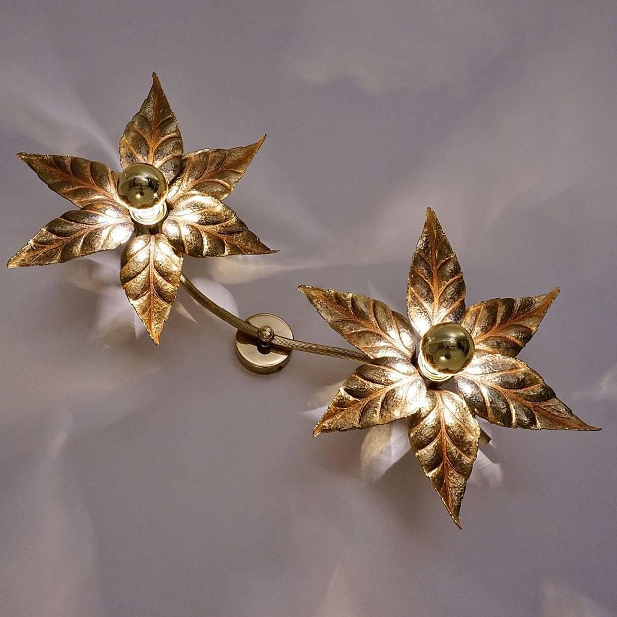 Nice set of brass flowers ceiling or wall lights in the style of designer Willy Daro manufactured, circa 1970s, Europe, Belgian. This decorative and beautiful large sculptural light consists of a pair of brass-plated flowers on a bar and circular
