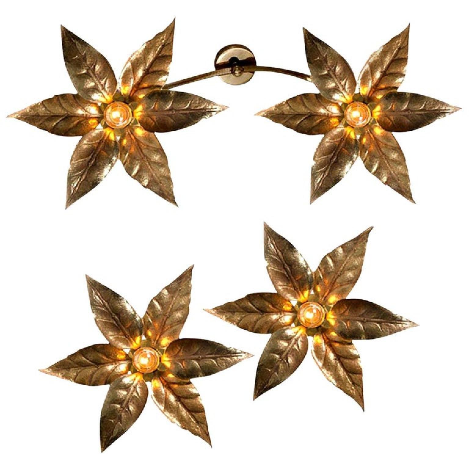Nice set of brass flowers ceiling or wall lights in the style of designer Willy Daro manufactured, circa 1970s, Europe, Belgian. This decorative and beautiful large sculptural light consists of a pair of brass-plated flowers on a bar and circular