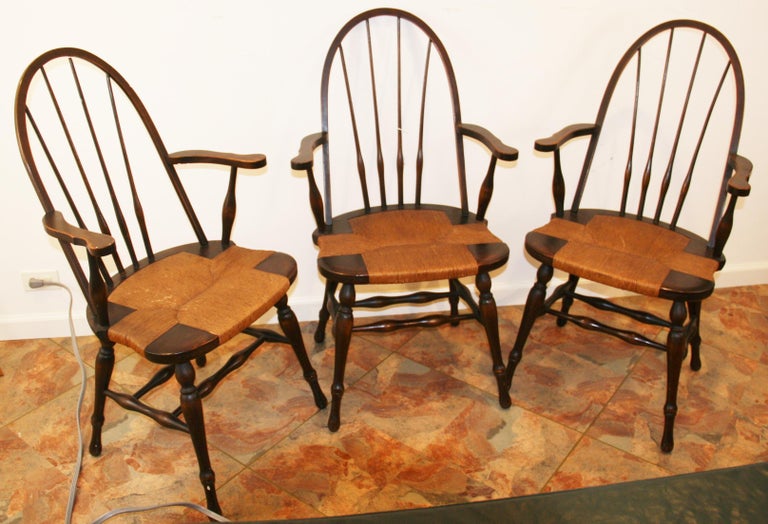 Set of 3 windsor chairs with rush seating in a walnut finish.