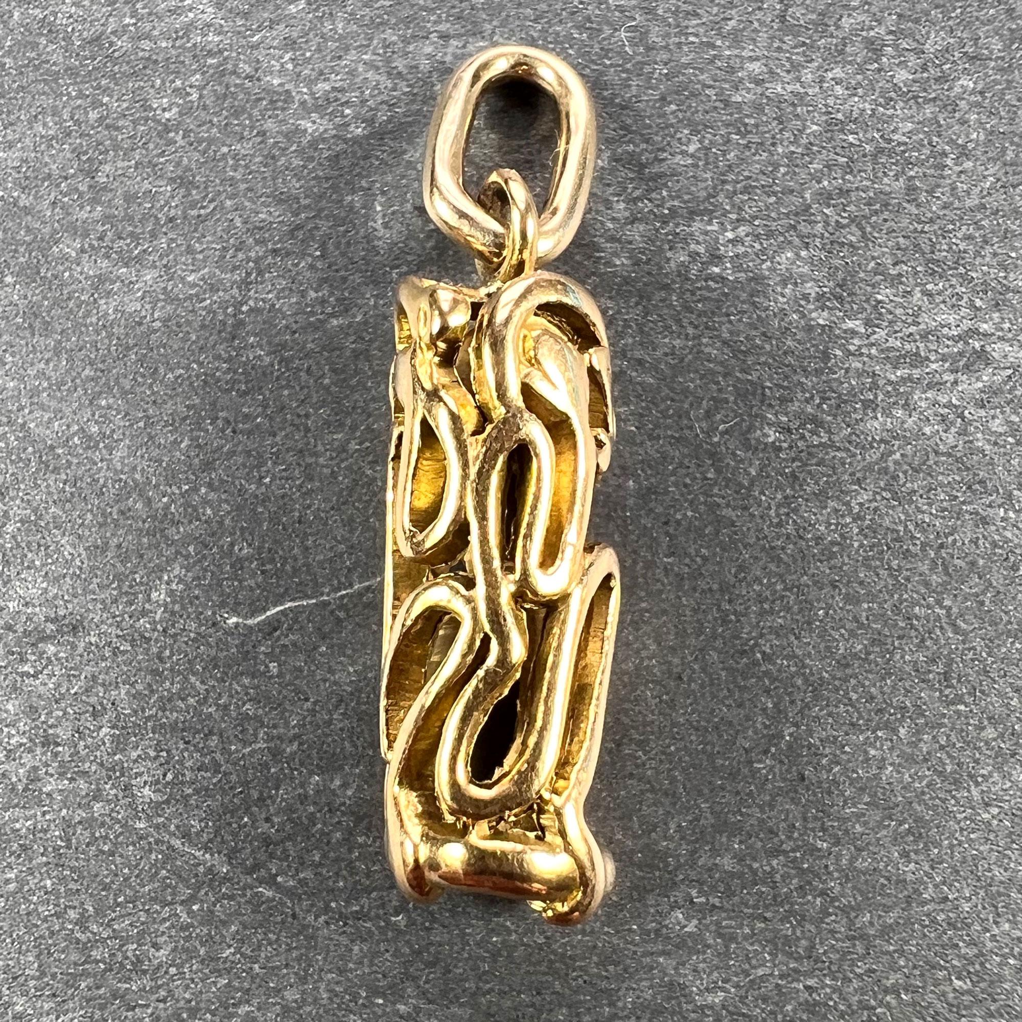 An 18 karat (18K) yellow gold charm pendant designed as a pierced cylinder depicting the three wise monkeys in the traditional poses for ‘see no evil’ ‘hear no evil’ and ‘speak no evil’. Unmarked but tested as 18 karat gold.

Dimensions: 1.8 x 0.5 x