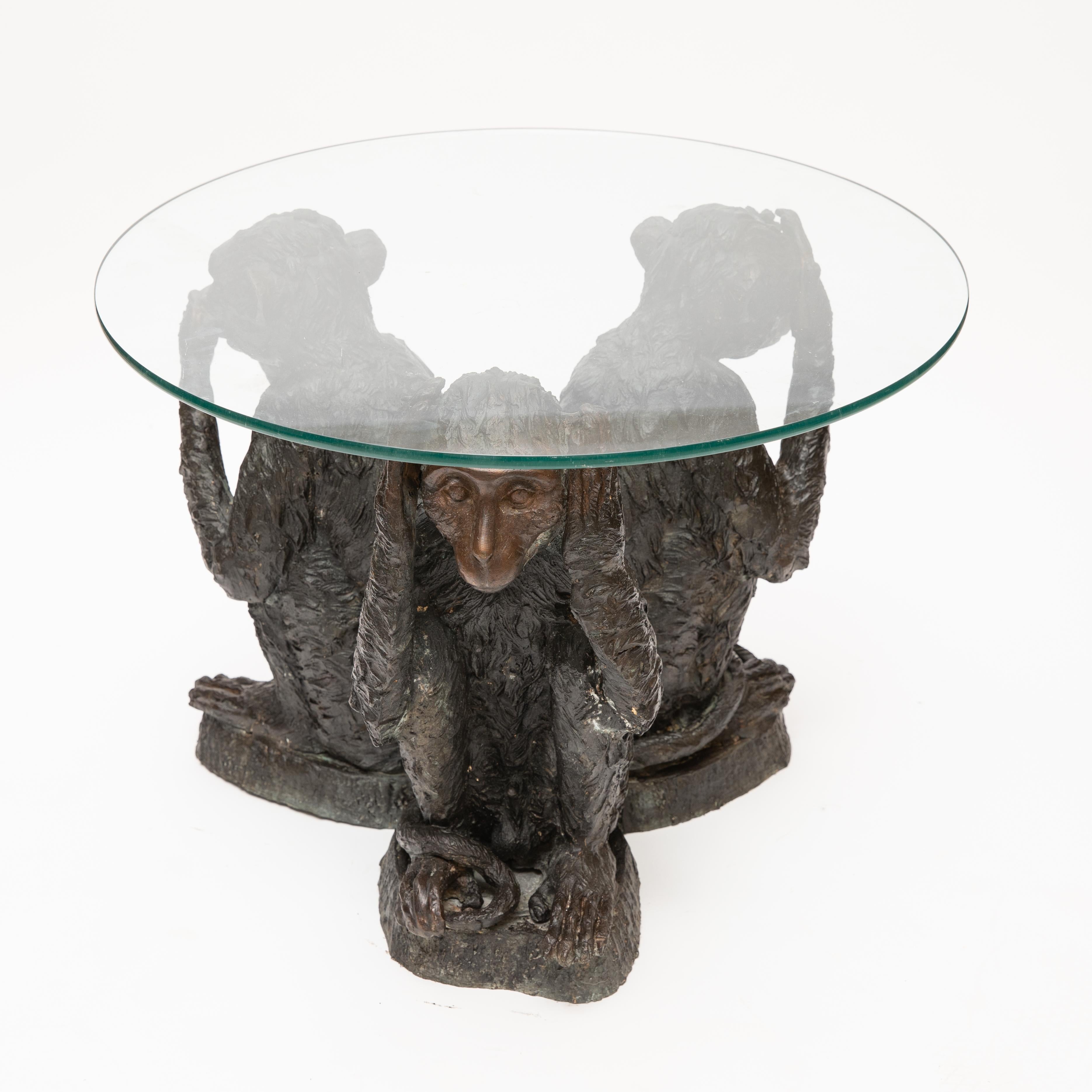 Midcentury bronze monkey based table with glass top. The table depicts the three wise monkeys embodying the proverbial principle 