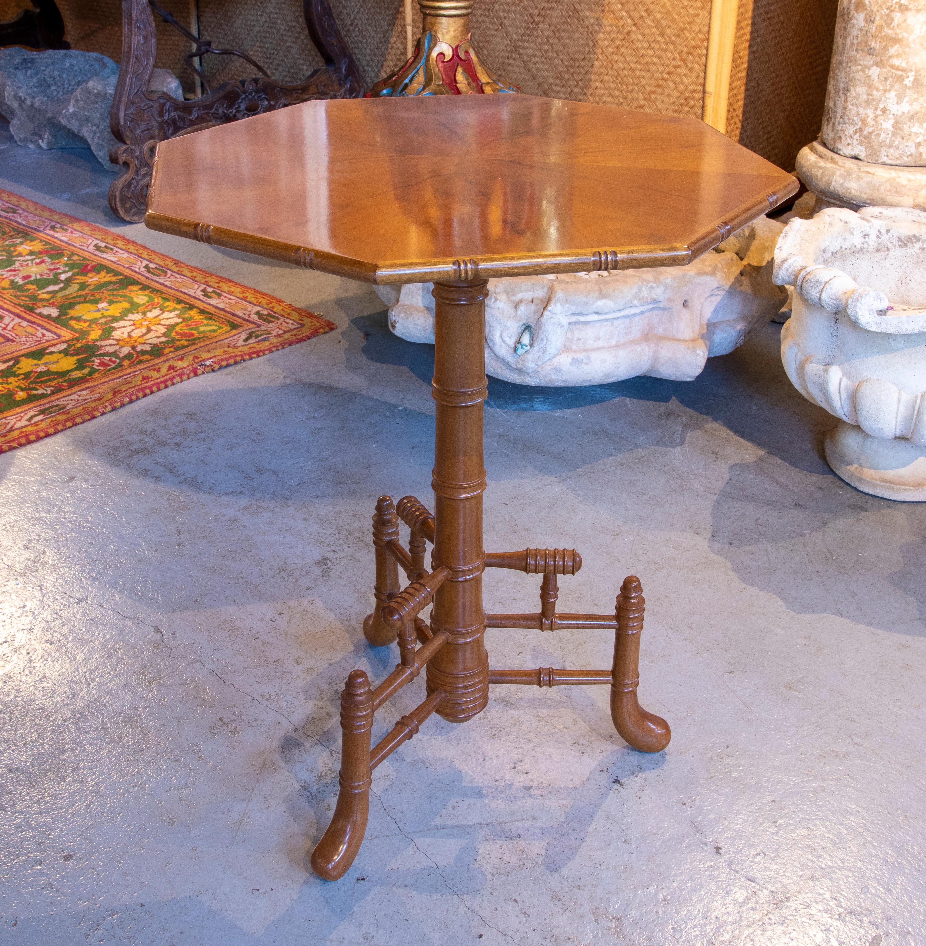 Three wooden side tables with octagonal top and bamboo-like legs.