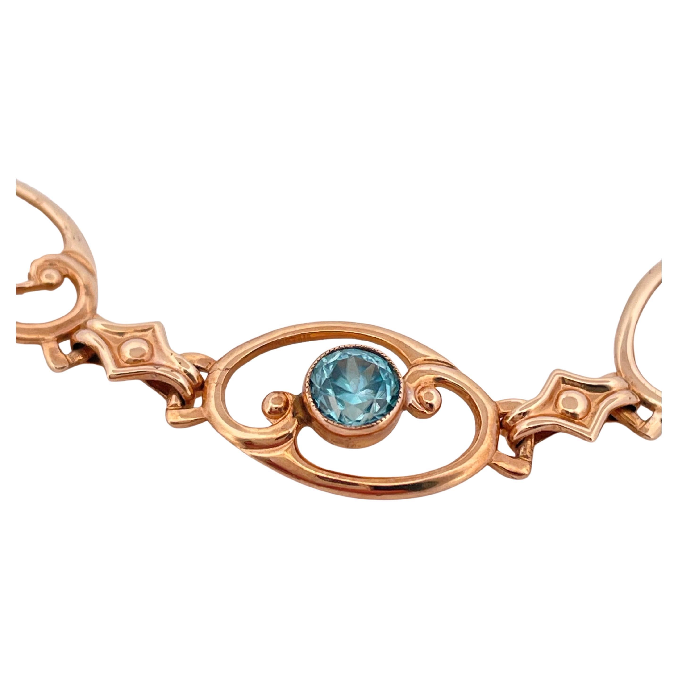 This exquisite Art Nouveau bracelet, circa 1900–1915, is crafted in 10k yellow gold and weighs 5.7 grams. Measuring 7 inches in length, it features a graceful series of openwork oval links adorned with scrolling and foliate motifs, hallmarks of