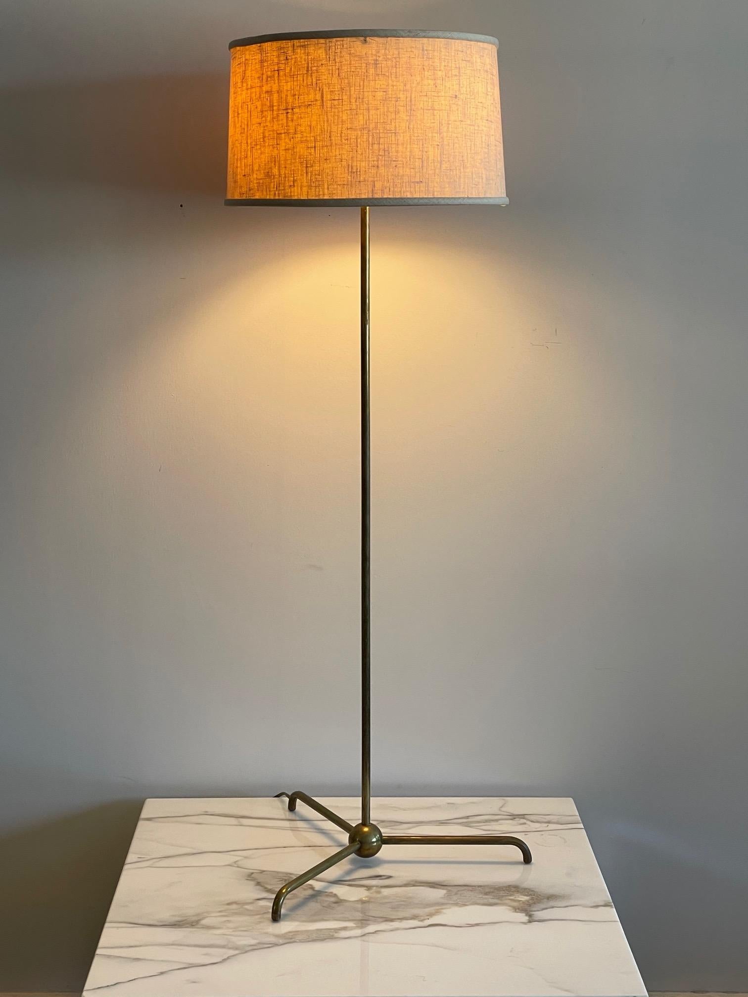 A rare T.H.Robsjohn-Gibbings designed for Widdicomb floor lamp. Brass with original shade and finial. Model #213 in the Widdicomb catalog.