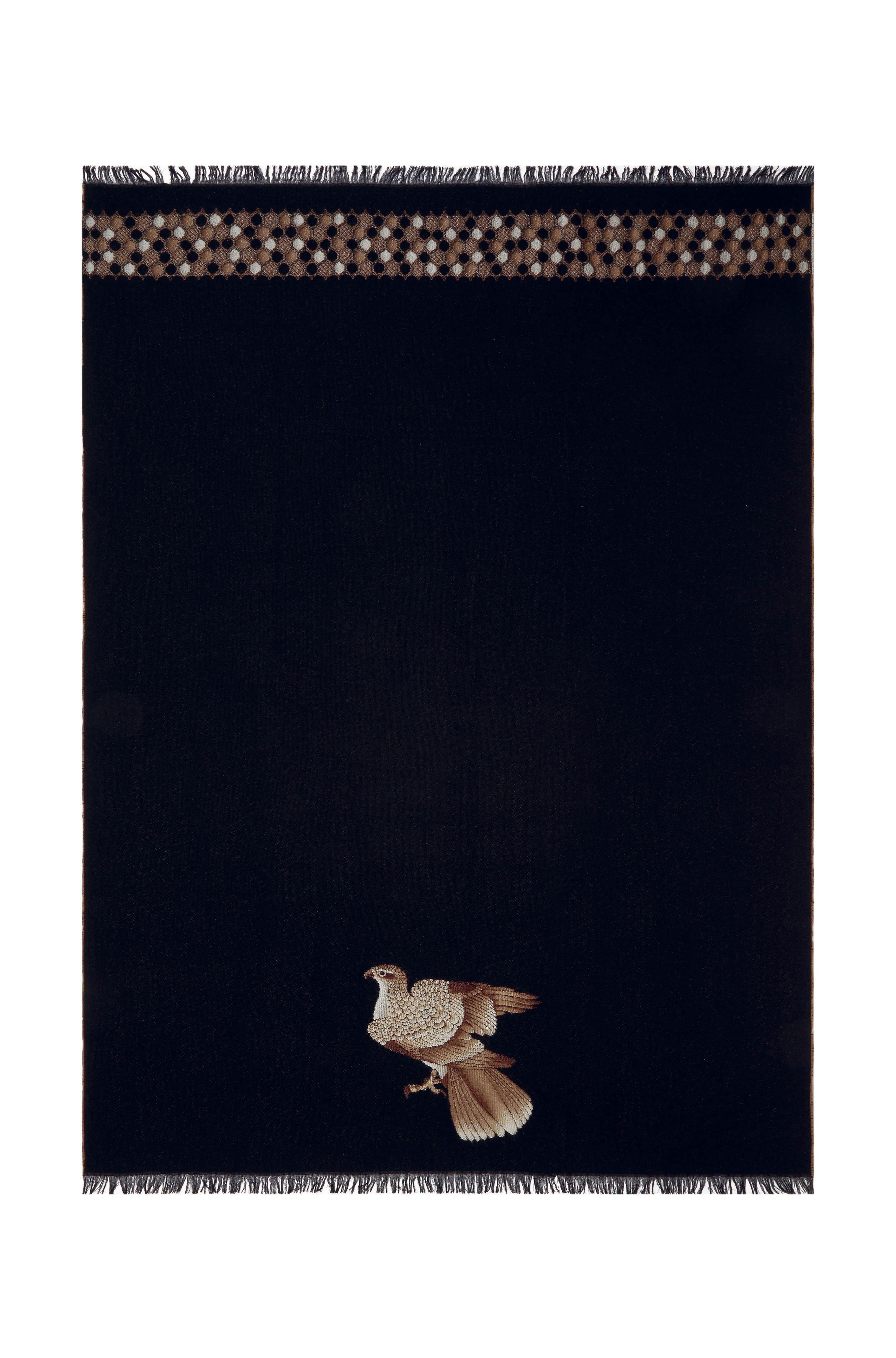 This is a rich black jacquard throw adorned with a precious hawk and a stripe with a geometric motif and finished with short fringes. The hawk is a Japanese symbol of power.