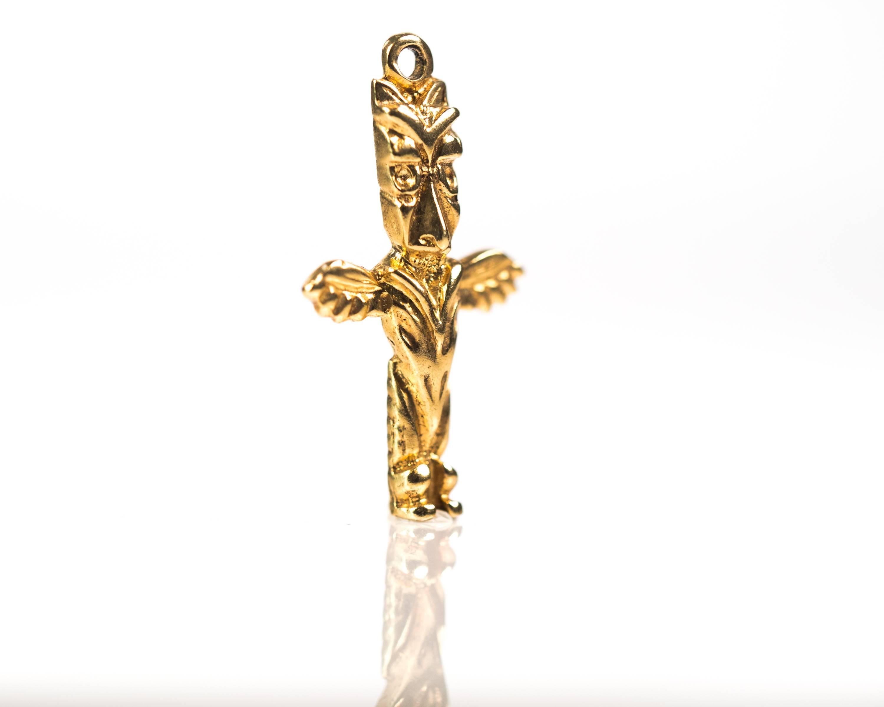 Thunderbird Totem Charm - 10 Karat Yellow Gold

This Gold charm is exquisitely detailed. The head has 2 eyes, a beak with 2 nostril indentations and geometric patterns above the eyes. Two peaked shapes sit at the top of the head on either side like