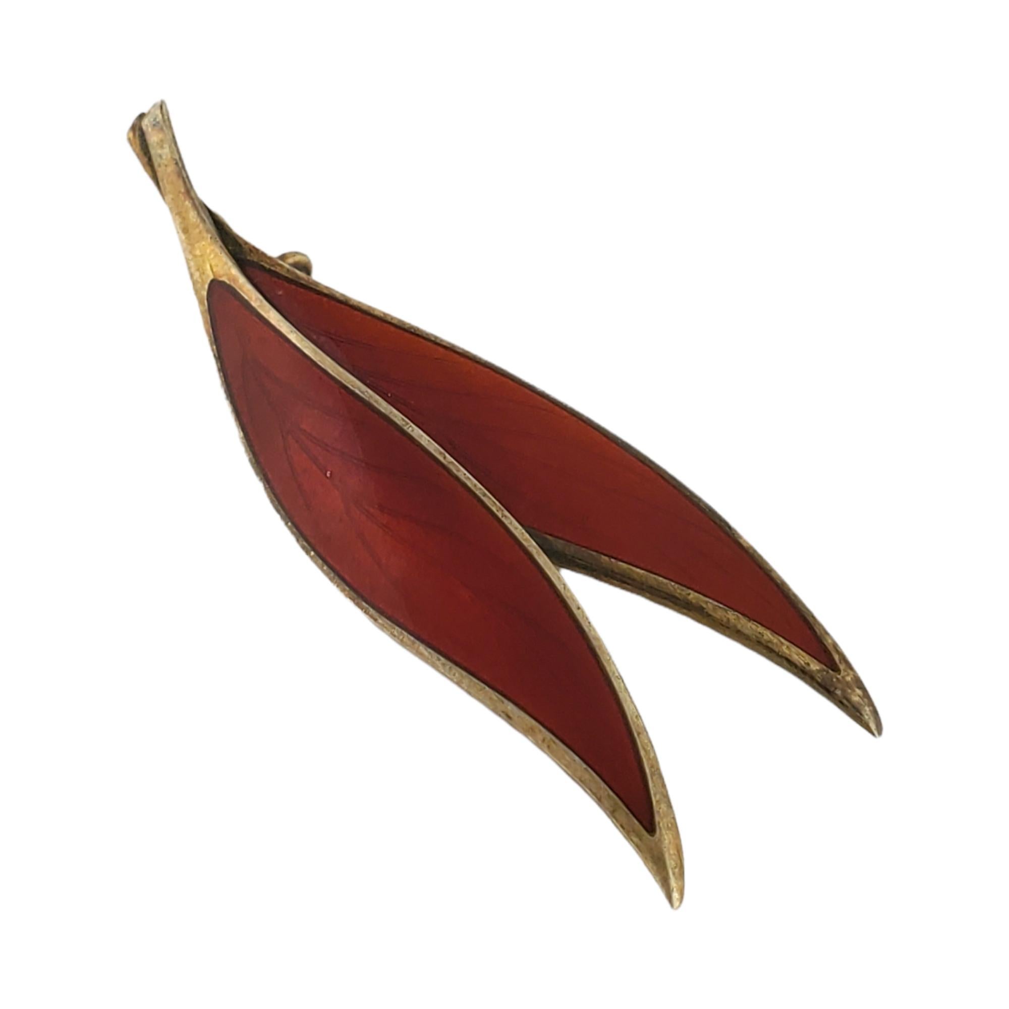 Thune Norway sterling silver gold vermeil red enamel leaf pin.

Marked: Thune Norway Sterling

Measures: 2 1/4