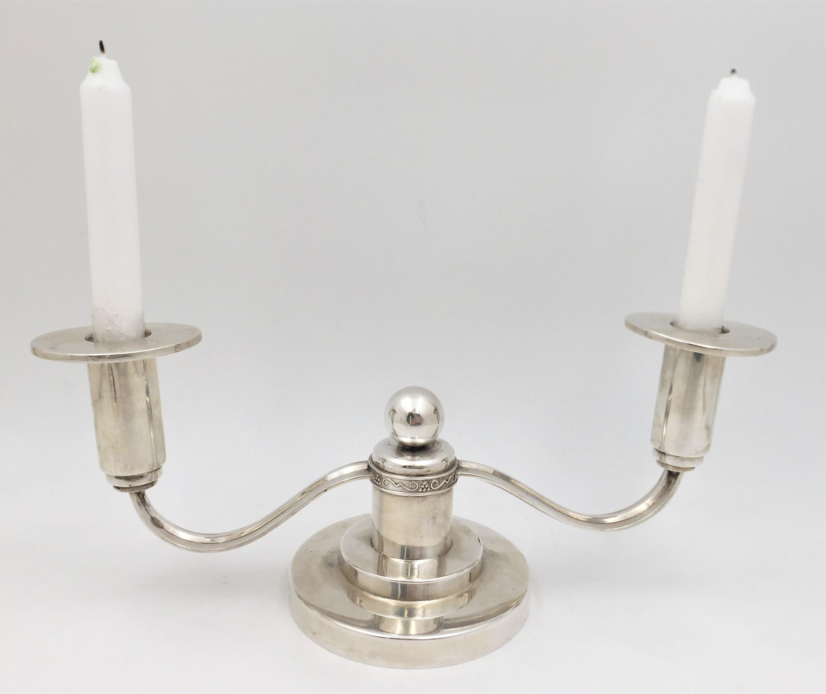 N.M. Thune, Norwegian 0.830 silver pair of 2-light candelabra in Mid-Century Modern style reminiscent of the work of the great silversmith Georg Jensen. With its elegant proportions and curvilinear designs, including a frieze of stylized motifs at