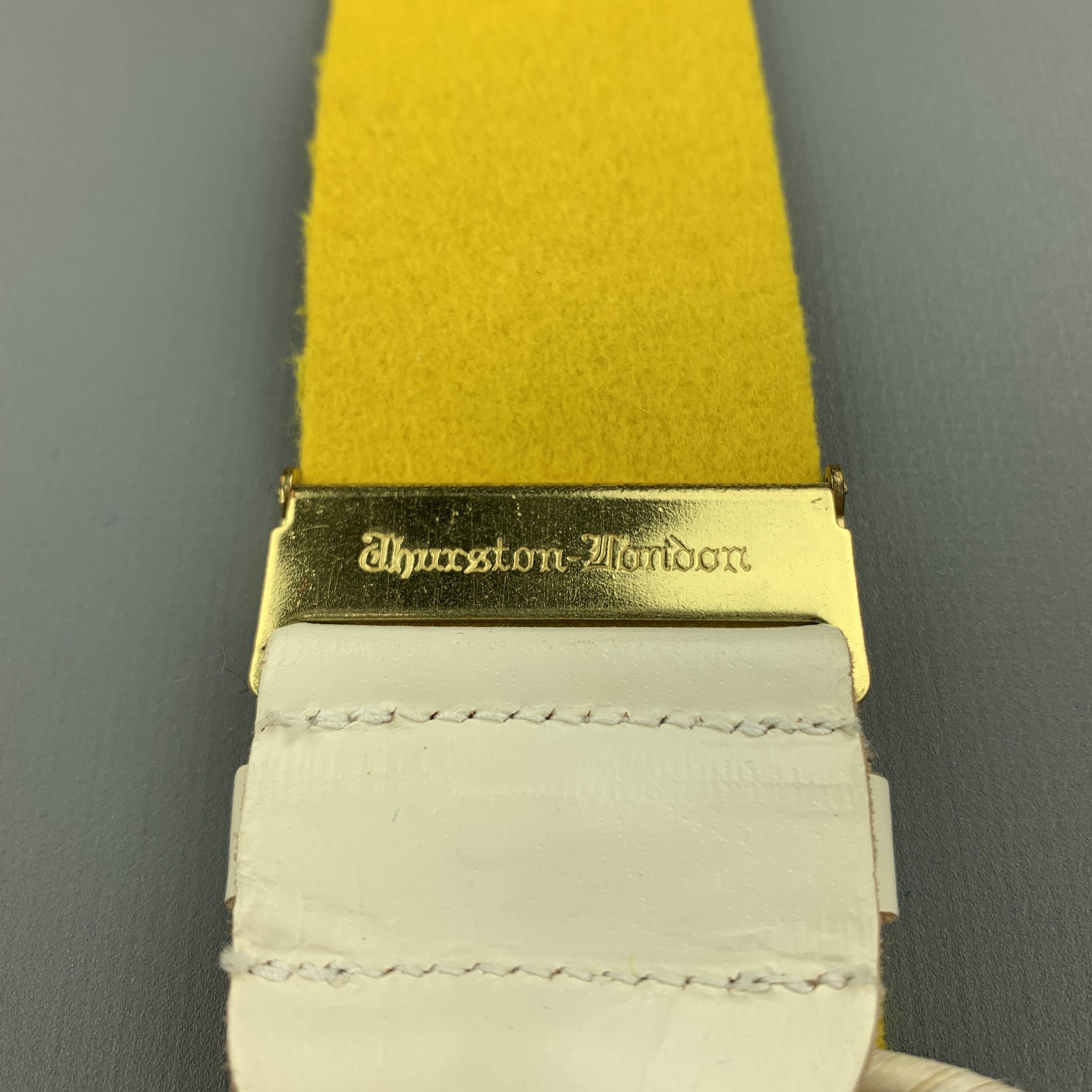 THURSTON LONDON suspenders comes in a yellow wool featuring a adjustable fit, leather trim, and includes trouser buttons. Made in England.

Excellent Pre-Owned Condition:

Measurements:

Width: 1.5 in.