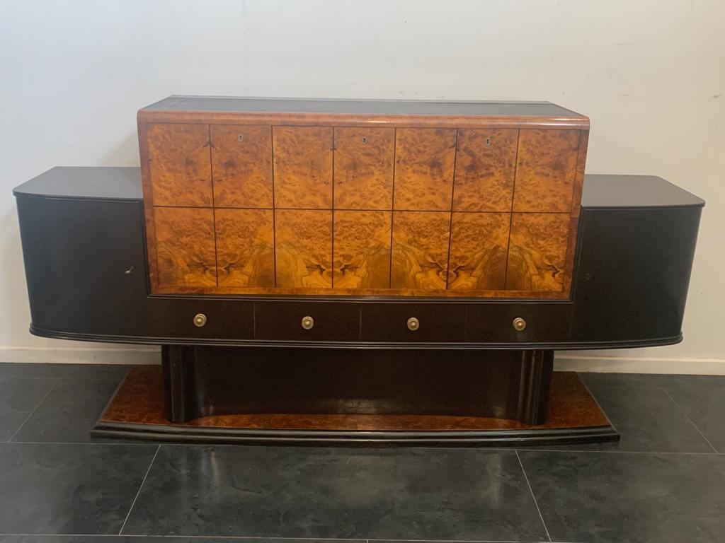 Sideboard, bar with ebonized body, the central part and tuja burl laid open-book divided into rectangles by ebony fillet of generous thickness.
Packaging with bubble wrap and cardboard boxes is included. If the wooden packaging is needed (fumigated