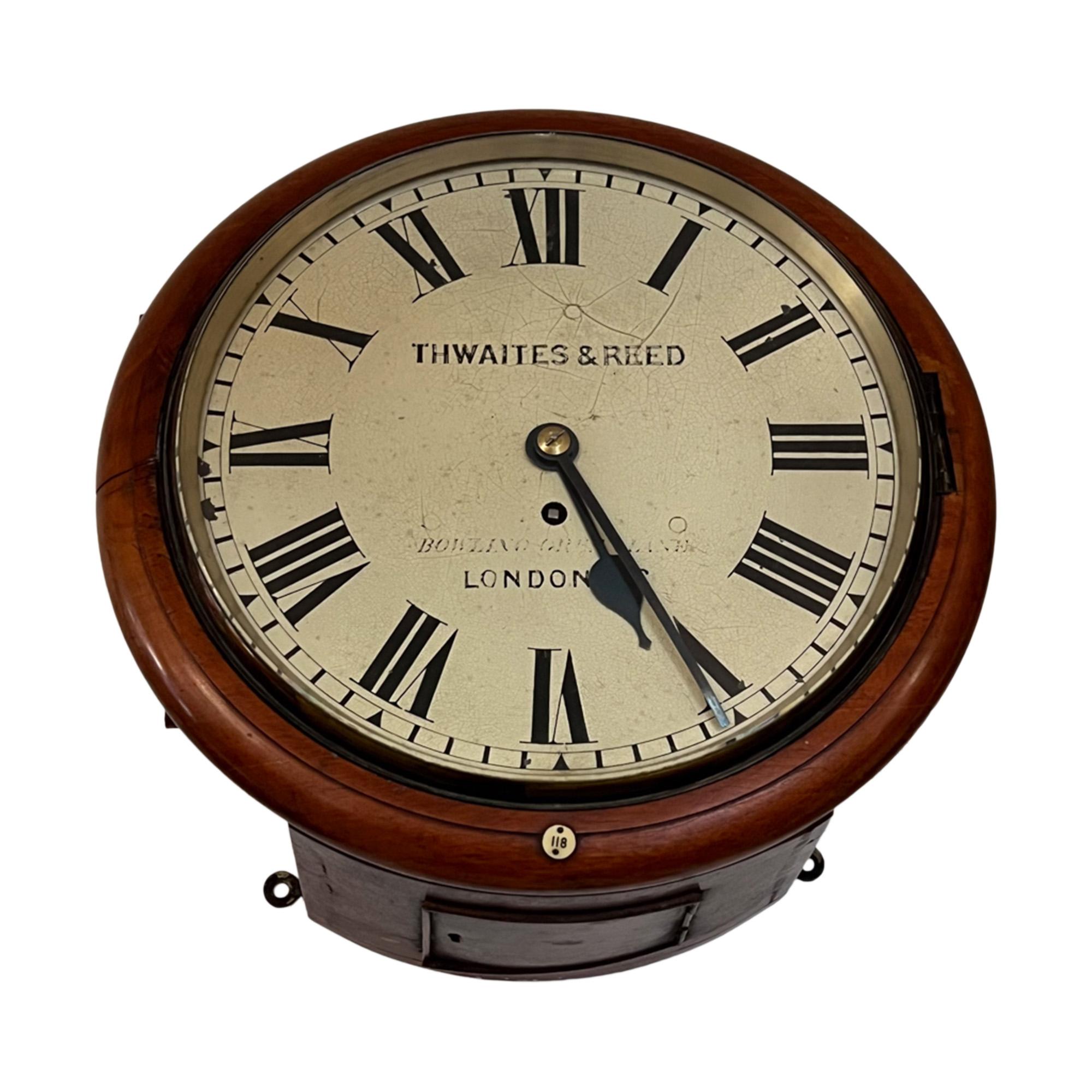 This beautiful wall clock was made by Thwaites and Reed in the late 19th century. 

The case is mahogany and numbered 118 with a small ivorine plaque - these clocks were made for establishments such as the Inns of Court and the Bank of England in