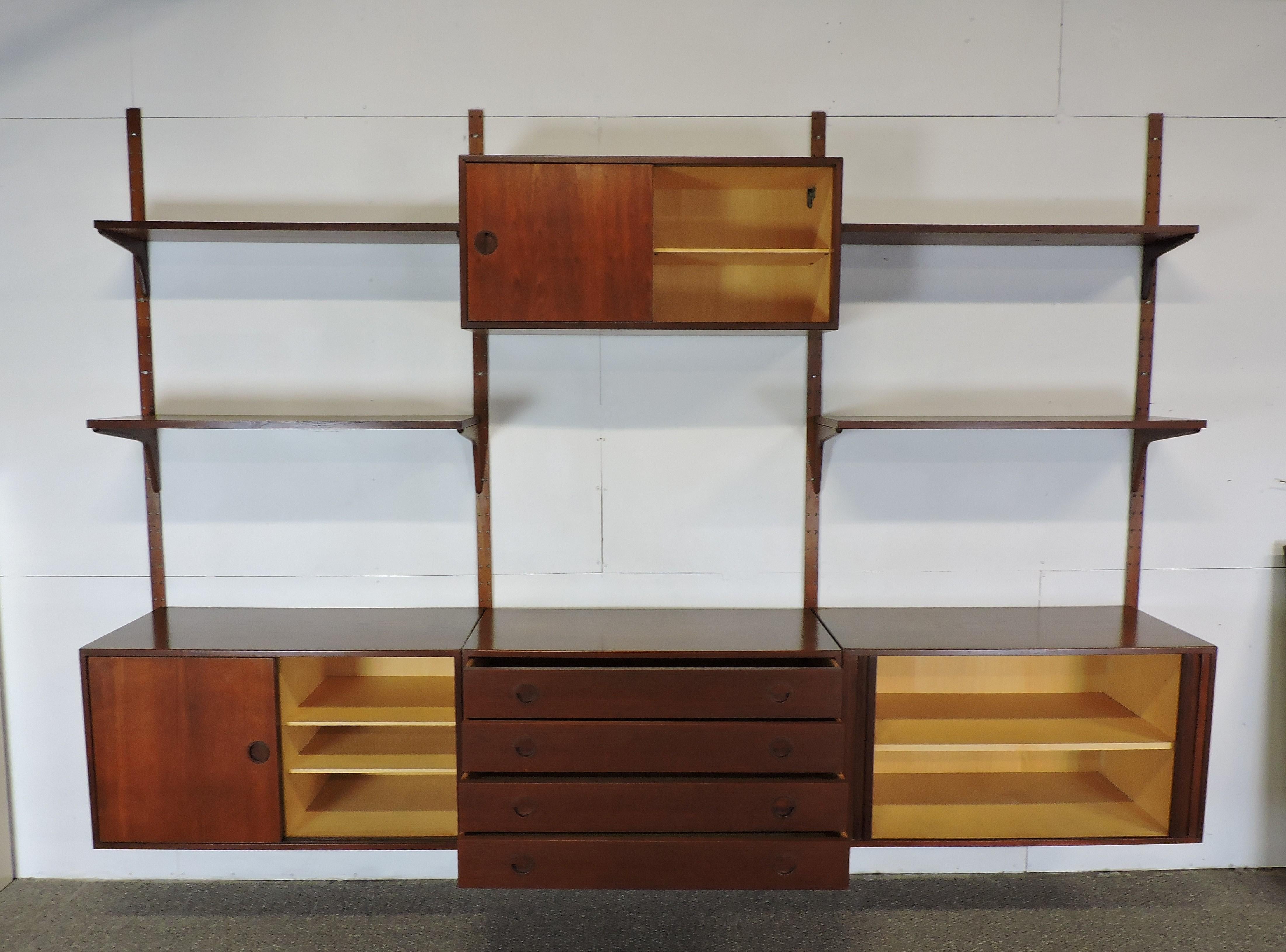 Large three bay modular wall unit designed by Rud Thygesen and Johnny Sorensen and made in Denmark by Hansen and Guldborg. This unit includes four poles, four modules and four shelves. Two of the cabinets have sliding doors with adjustable shelves,