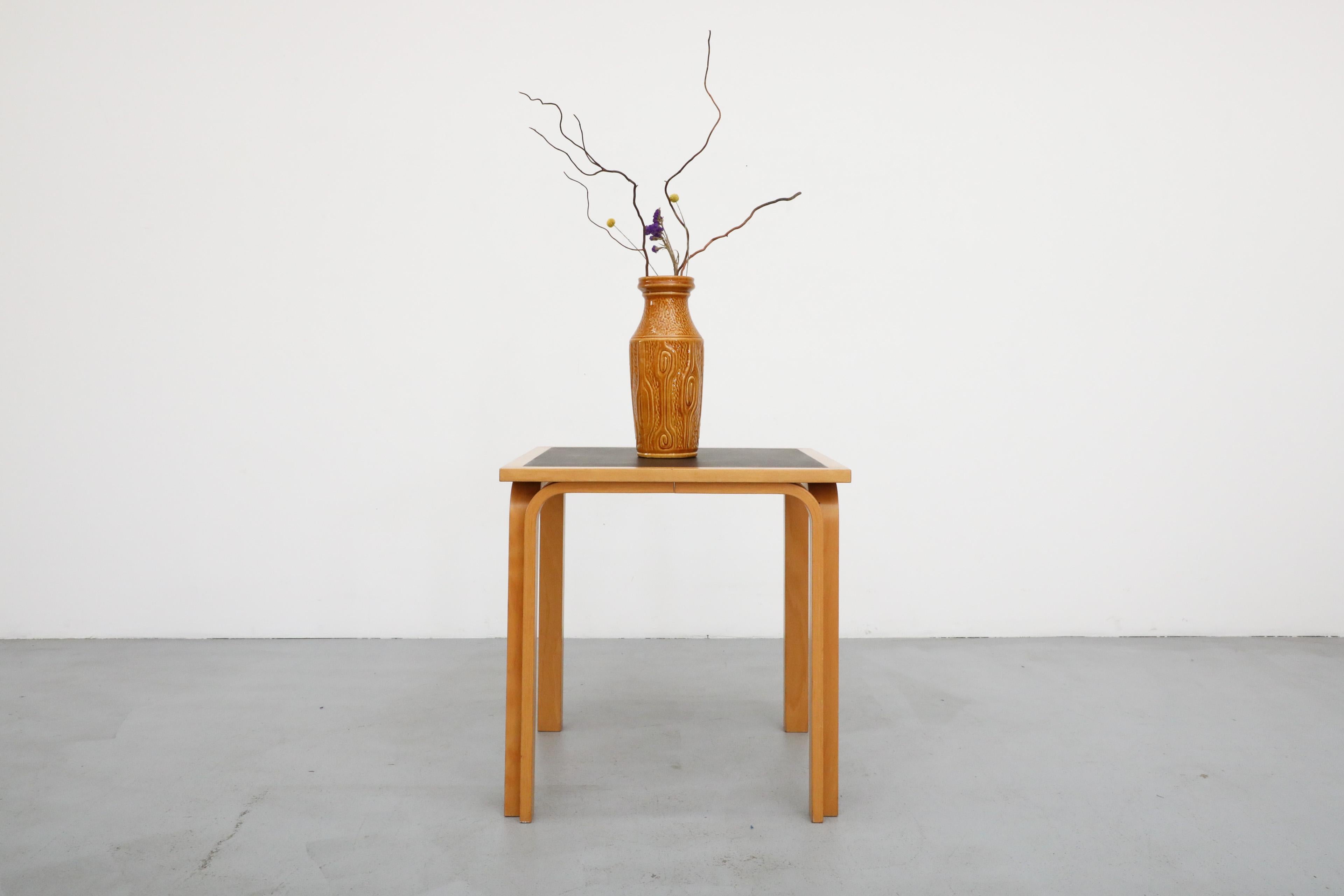 Mid-Century Magnus Olesen square table by Rud Thygesen & Johnny Sørensen with bent birch legs and black formica inset top. In original condition with visible wear including some markings on the top and frame. Other larger version available and