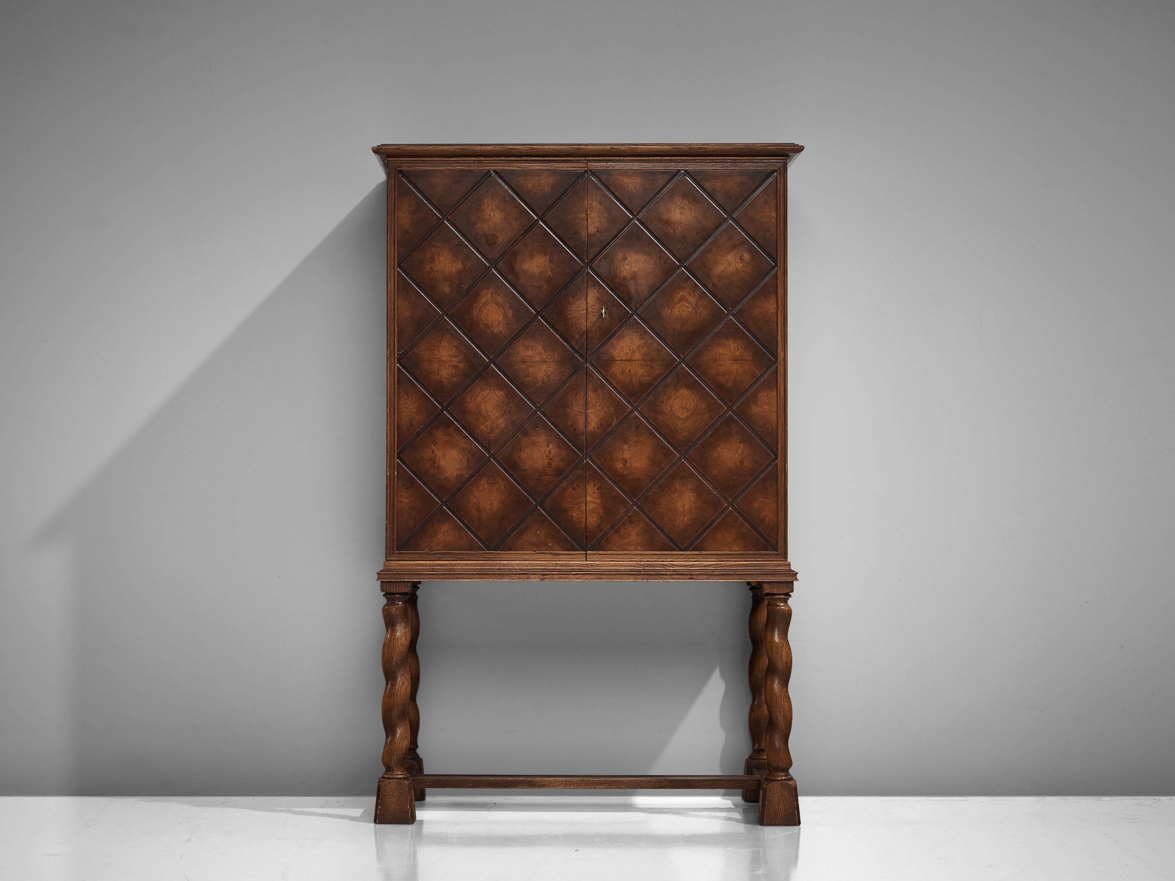 Thysells Möbler, high-legged sideboard, oak, Sweden, 1940s

This elegant sideboard is designed according to the stylistic principles of the so-called Swedish Grace style. The corpus features intricate geometric carvings with squares and diagonal
