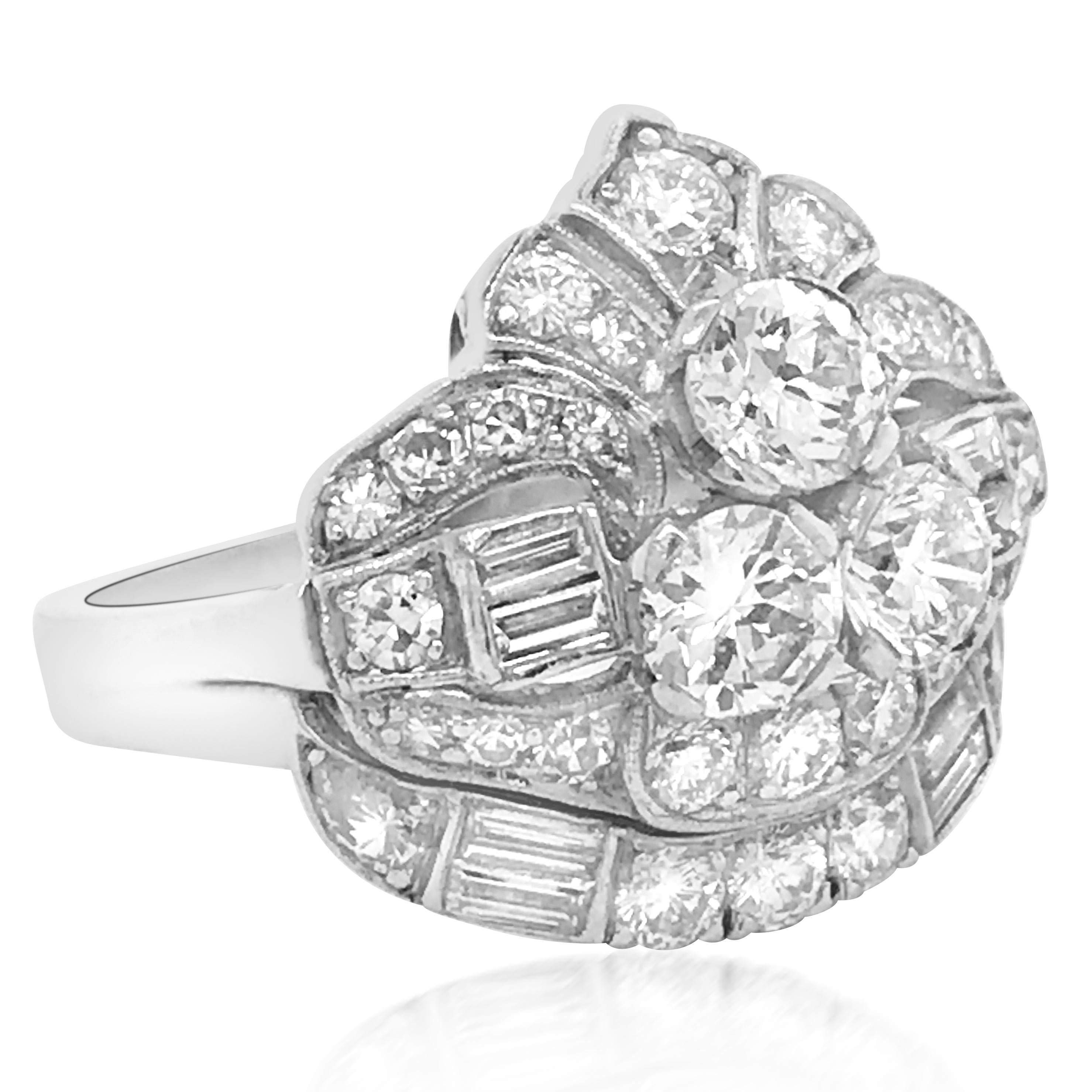 This stunning and classic Art Deco diamond ring is crafted in solid platinum, weighing 11 grams and in ring size 8.5. Centered with three old-European cut diamonds weighing approx. 0.35ct each, this alluring ring is further adorned with old-European