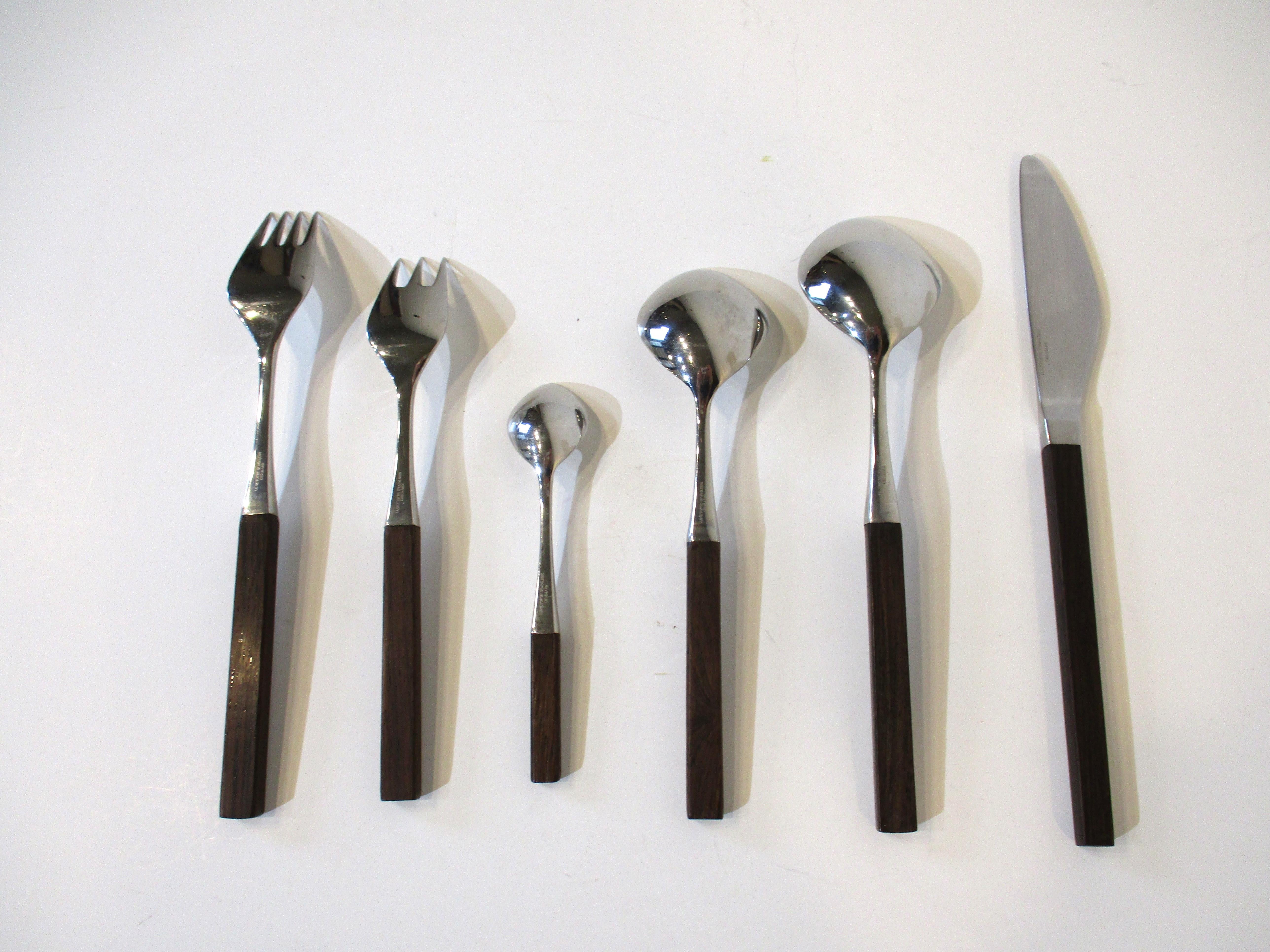 A fine 52 piece flatware set having eight 6 piece place settings and four serving pieces 2 large spoons and two condiment forks . The setting for eight contains salad , dinner forks , soup , coffee and desert spoons and knife all with rosewood