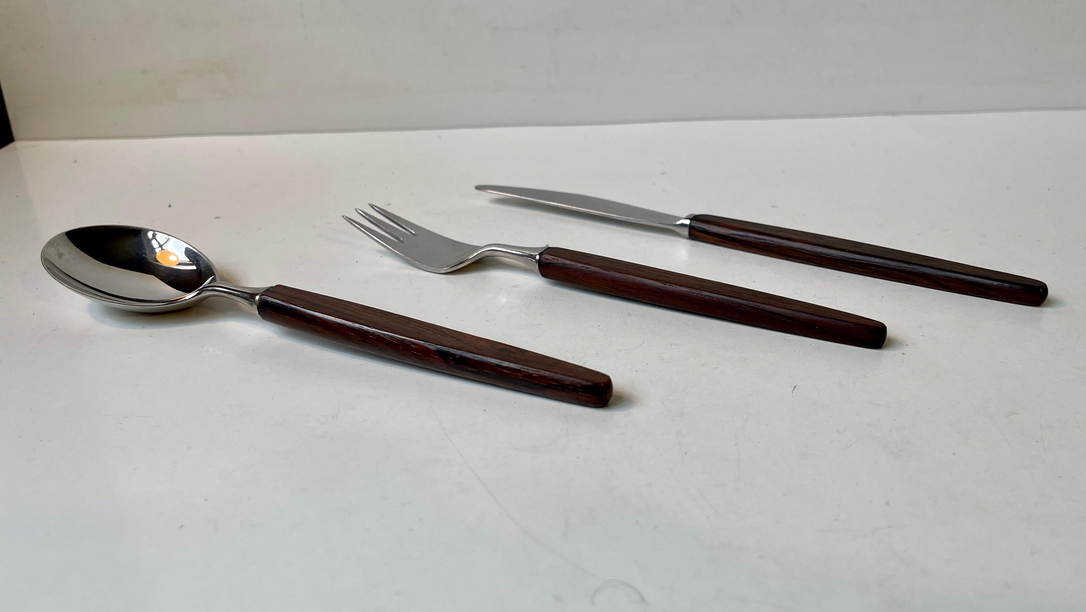 Iconic Scandinavian flatware dinner set for 12 persons. 12 dinner knives, 12 dinner forks and 12 soup spoons. Designed by Norwegian industrial designer Tias Eckhoff circa 1960 and made by Dansk Knivevarefabrik/Lundtofte during the 1960s. Made from