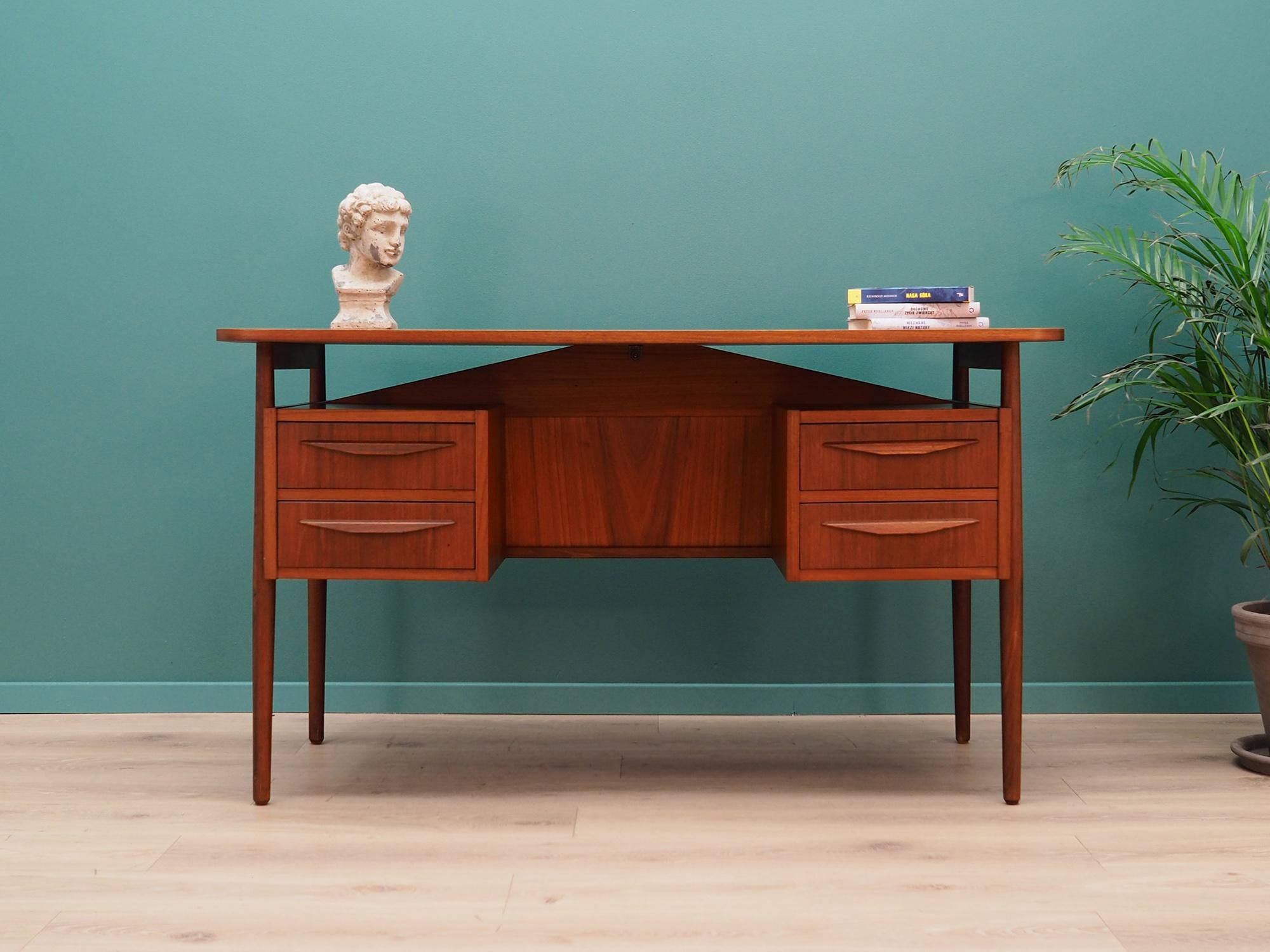 Fantastic desk from the 1960s-1970s. Scandinavian style, designed by Gunnar Nielsen Tibergaard. Top finished with teak veneer, construction made of solid teak wood. Desk with four drawers and a bookcase at the back. Preserved in good condition