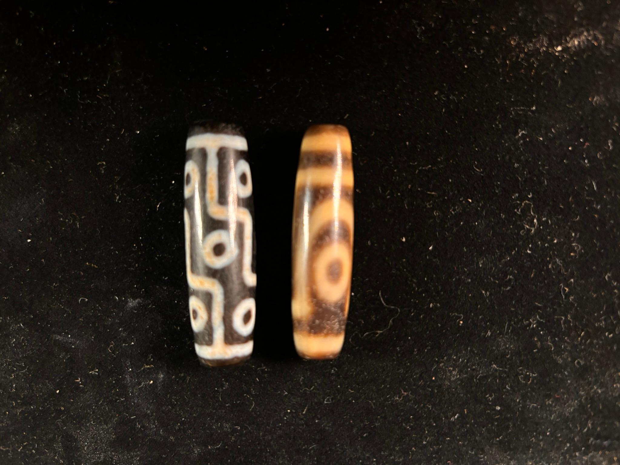 A unique pair (2), valuable and powerful Protection Amulet Dzi from Tibet

An  old Tibetan or Central Asian two and nine eye agates Dzi Beads dating to the early 20th century. These beads would make handsome spiritual talismans . 

The  Dzi beads