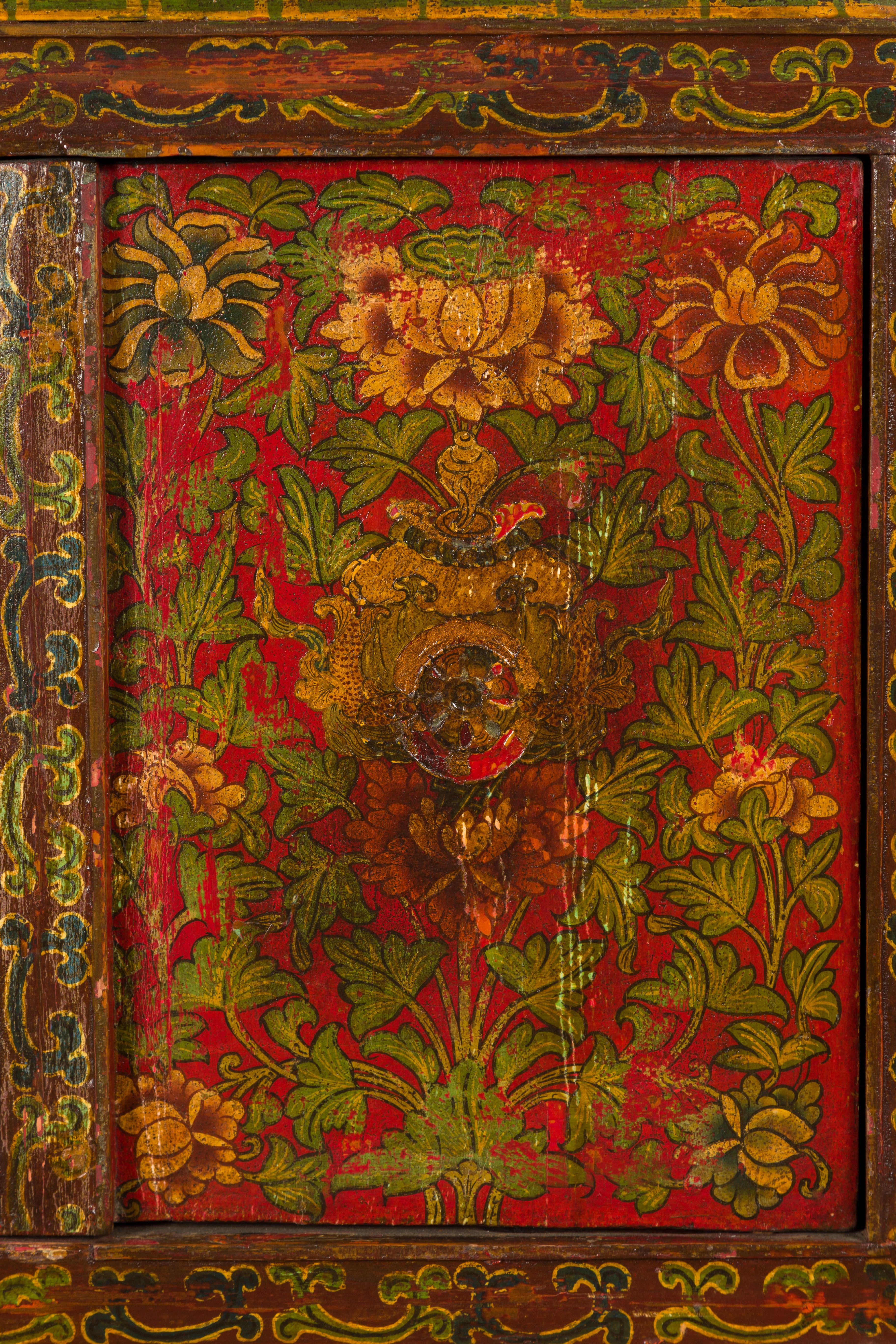 Wood Tibetan 19th Century Cabinet with Hand-Painted Floral Décor on Red Ground For Sale