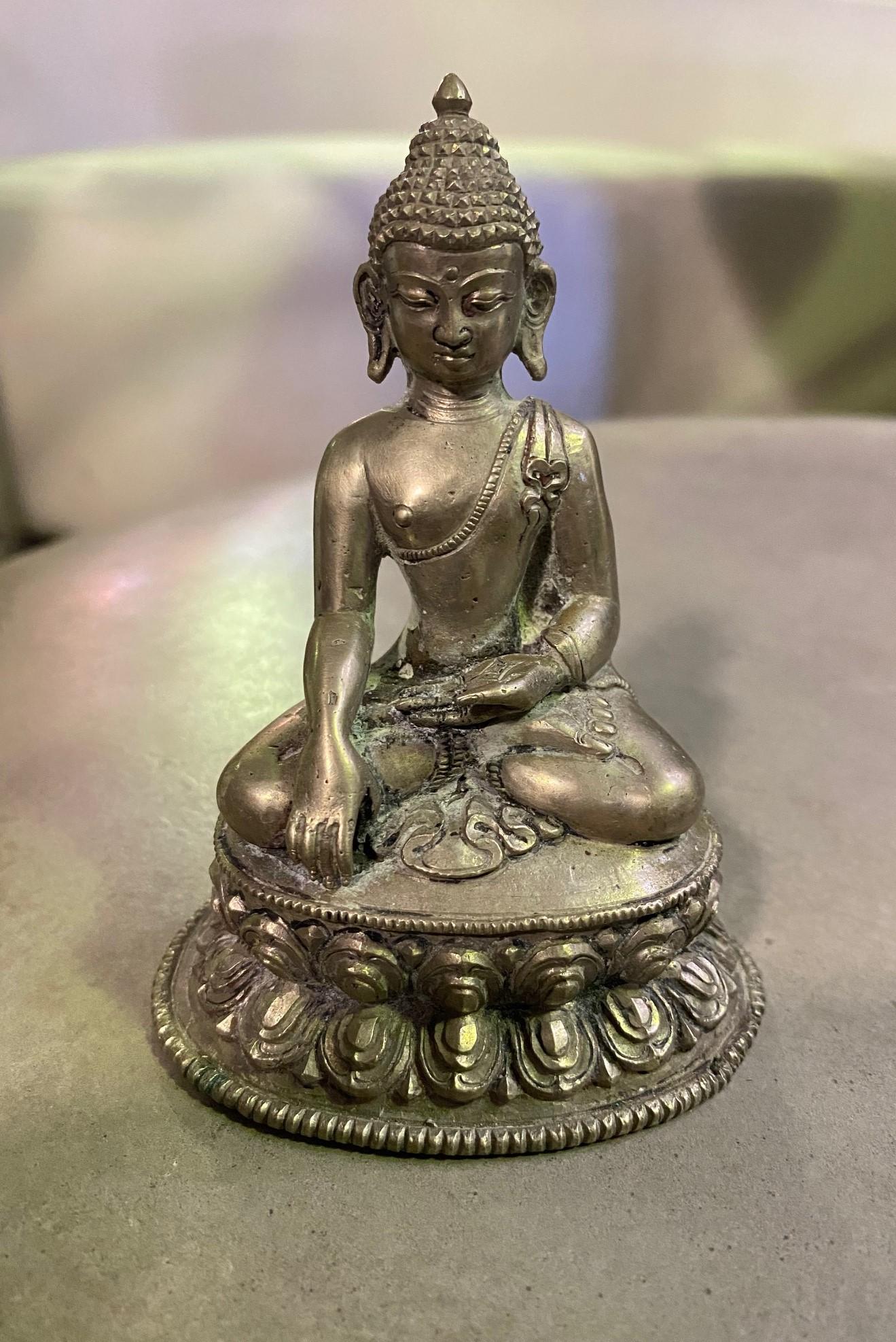 A nice Buddha with a wonderful feel and heft to it. 

Stamped/marked on the base. 

It may have some Tibetan silver in it but we have not tested the metal. 

We are listing it as 20th century but could be older. 

Would be a nice addition to