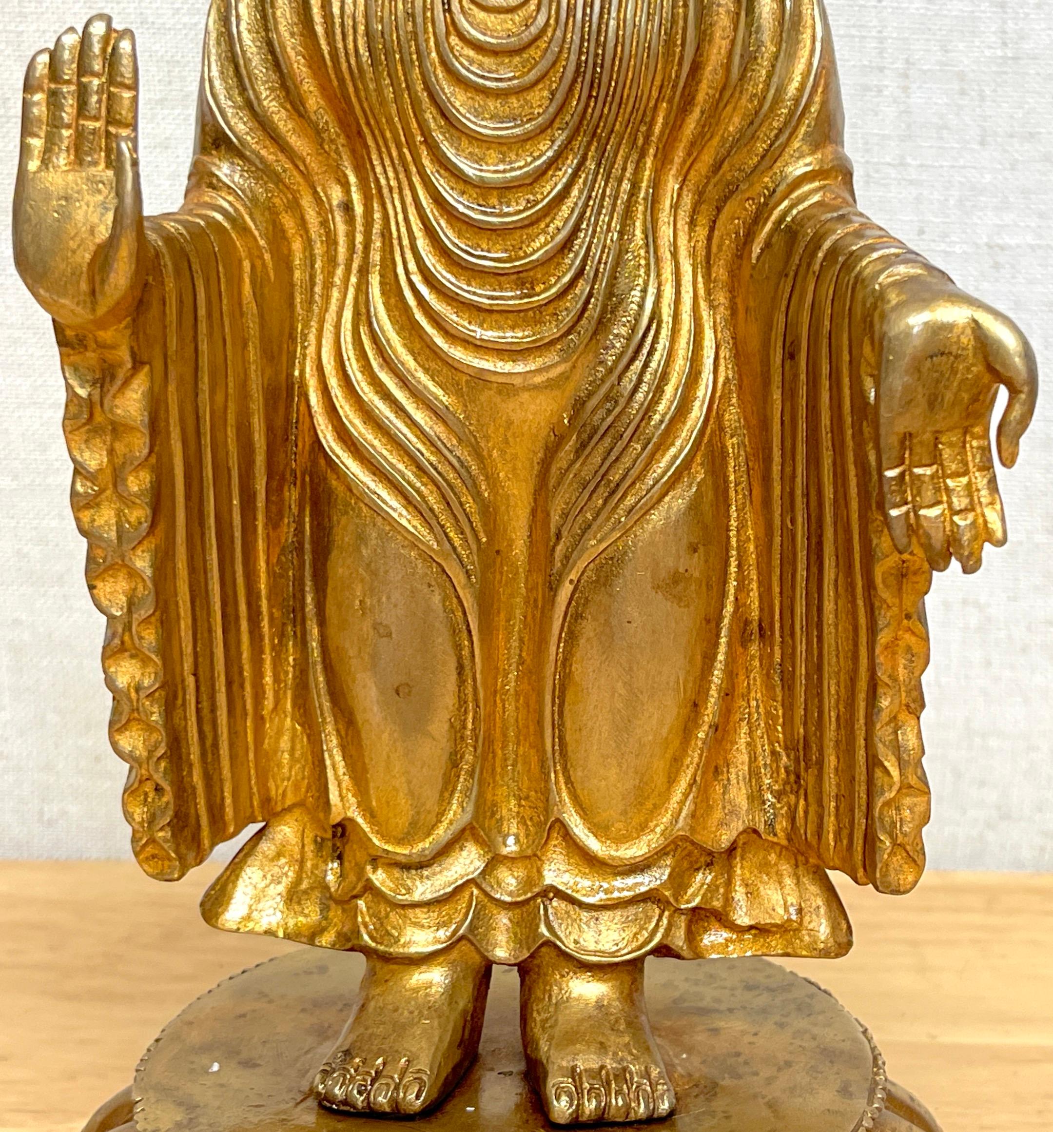 Cast Tibetan Bronze Standing Gilt Bronze Buddha Offering Protection For Sale