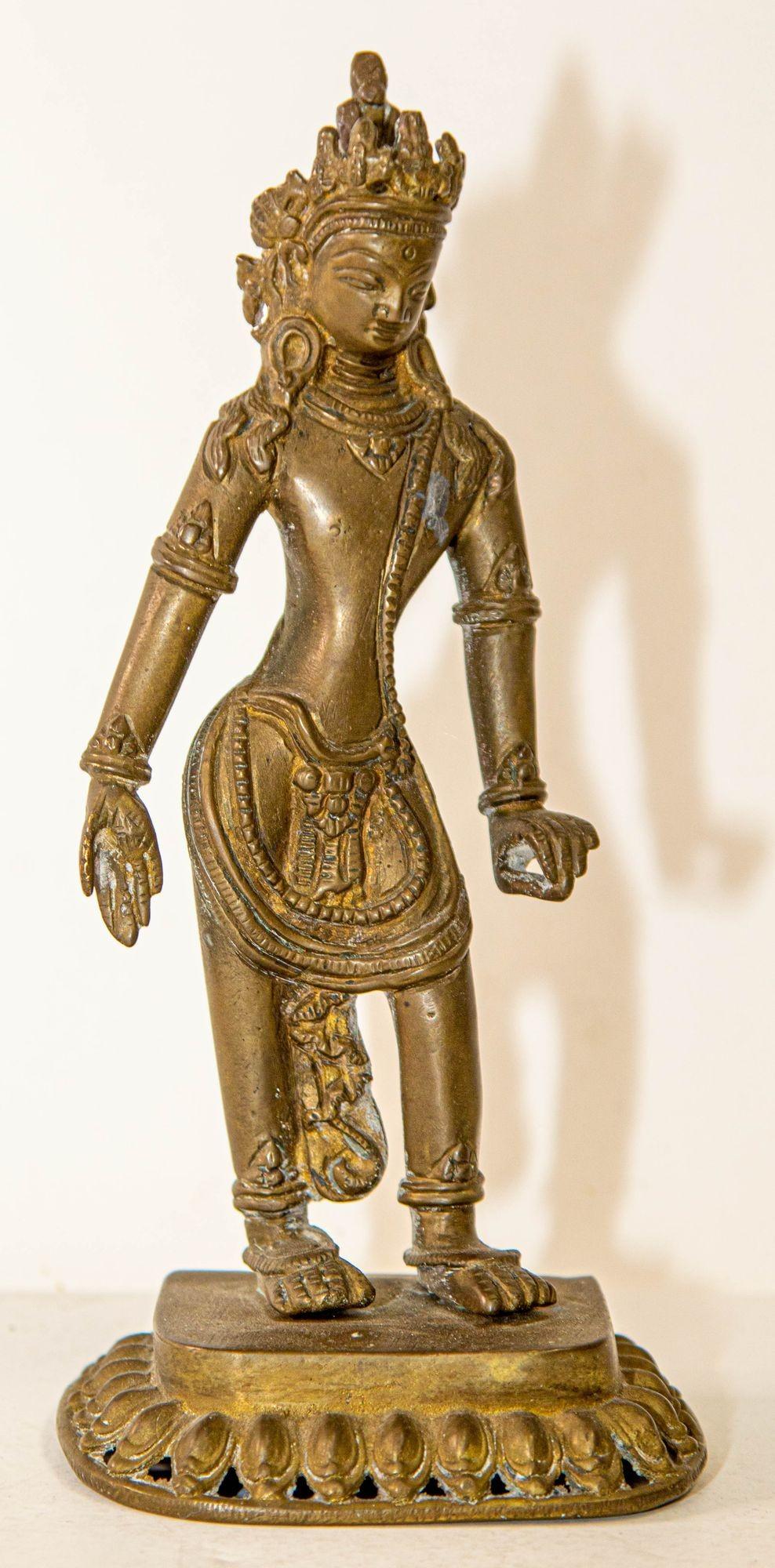 A metal cast bronze finish on brass in beautiful posture figure of Tibetan Buddhist Padmapani Deity Avalokiteshvara 
Beautiful Asian sculpture after the Bodhisattva Avalokiteshvara (Padmapani, bearer of the lotus)
Dimensions: Height : 8.5 inches