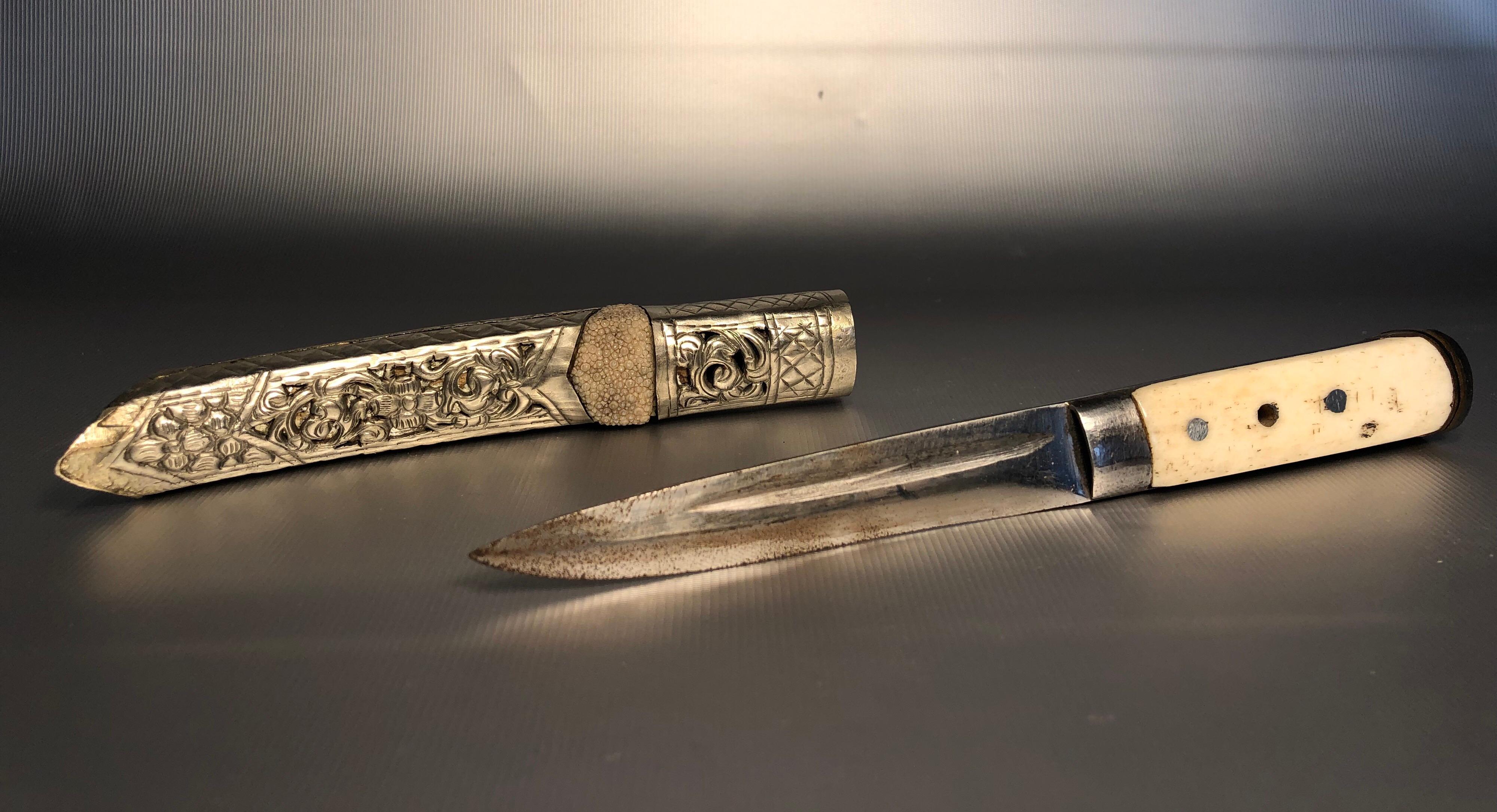 Tibetan dagger. Blade and bone grip. Silver ornate scabbard over 100 years old.