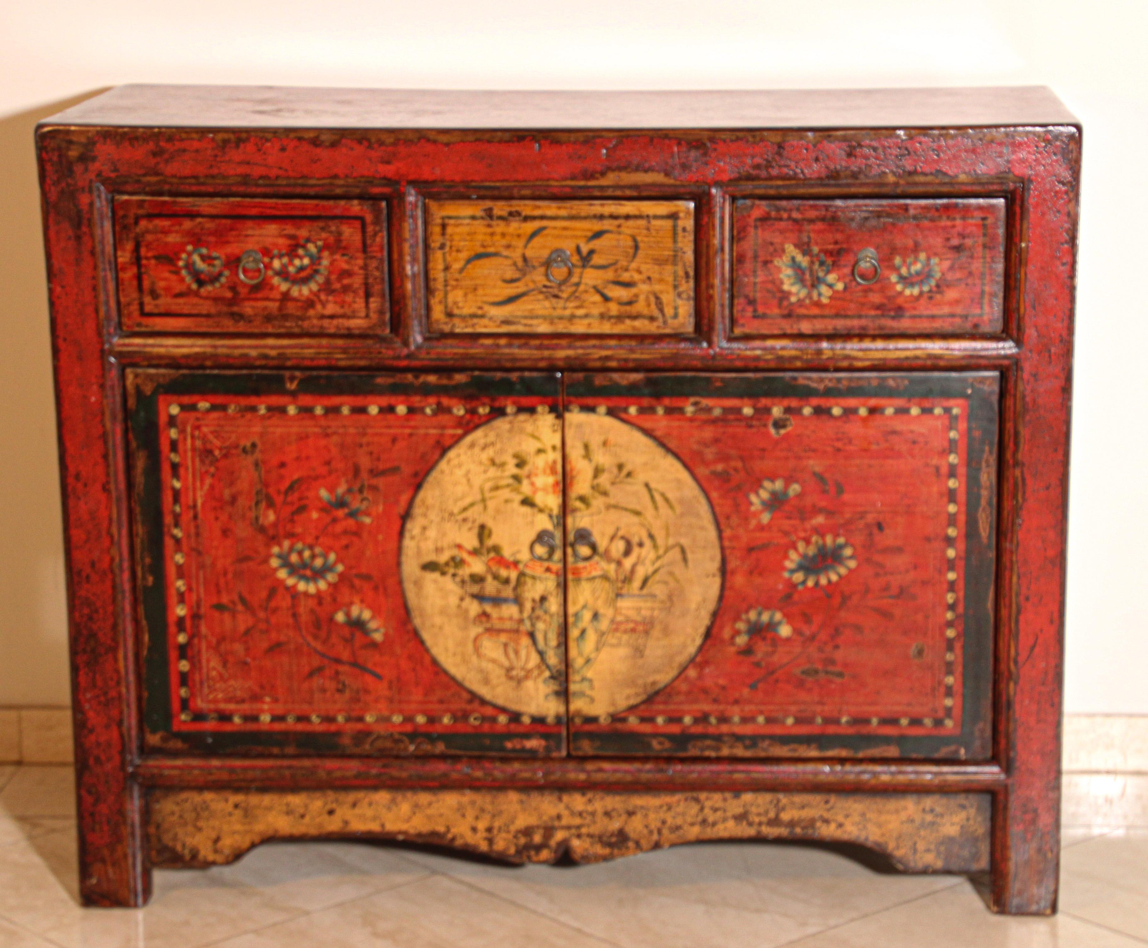 Handcrafted Tibetan dowry chest cabinet, polychrome floral designs hand painted in front.
Very elegant Bohemian style with simple modern lines.
Two doors opening, 3 drawers on top.
Great to add in a Moroccan, Bohemian, Spanish Moorish room for its
