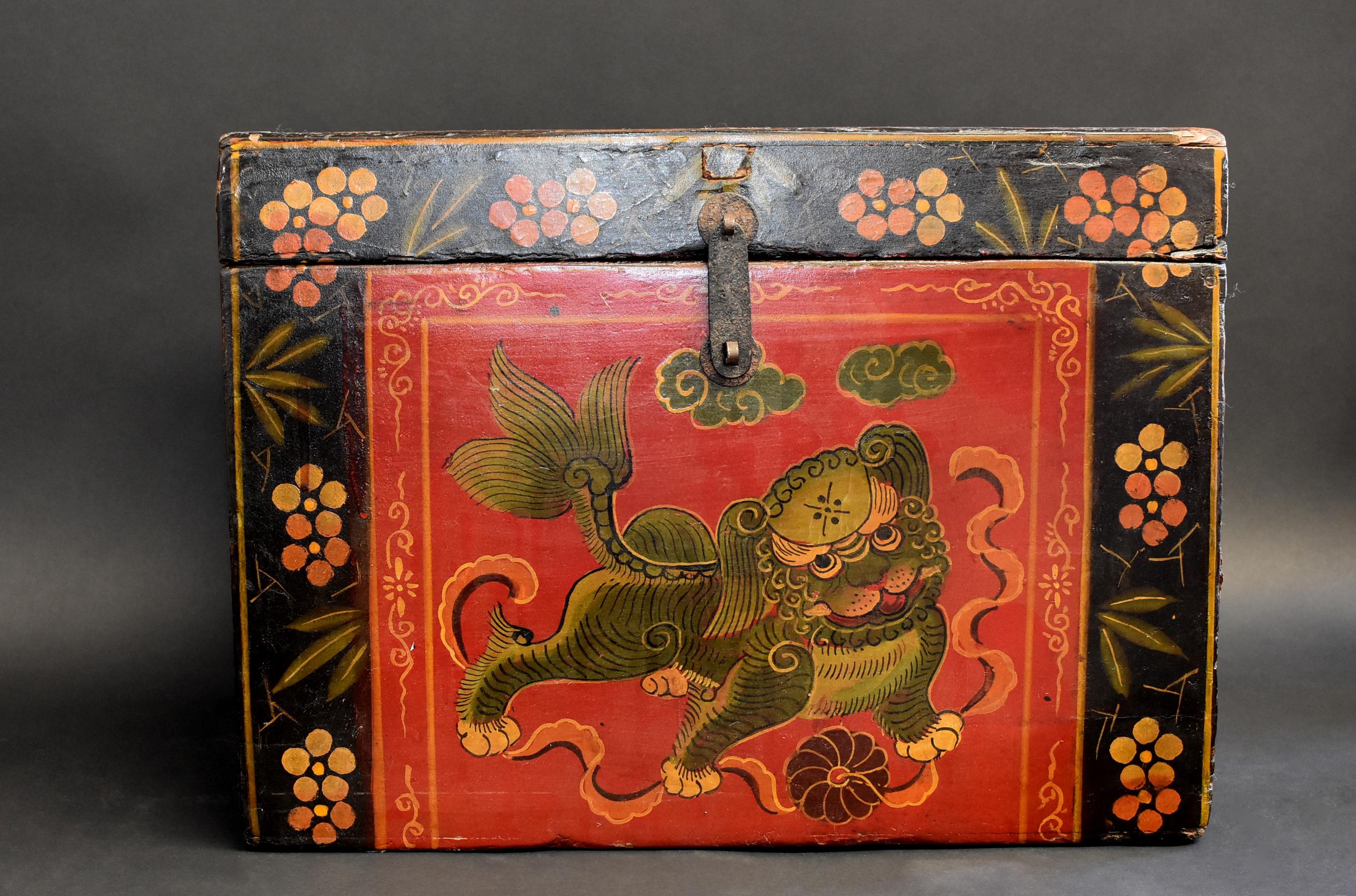 A wonderful, hand painted Tibetan box featuring a foo dog playing with ribbons and ball. Classic Tibetan border with flowers and bamboo leaves integrates Chinese style. Solid wood construction . Ample storage.