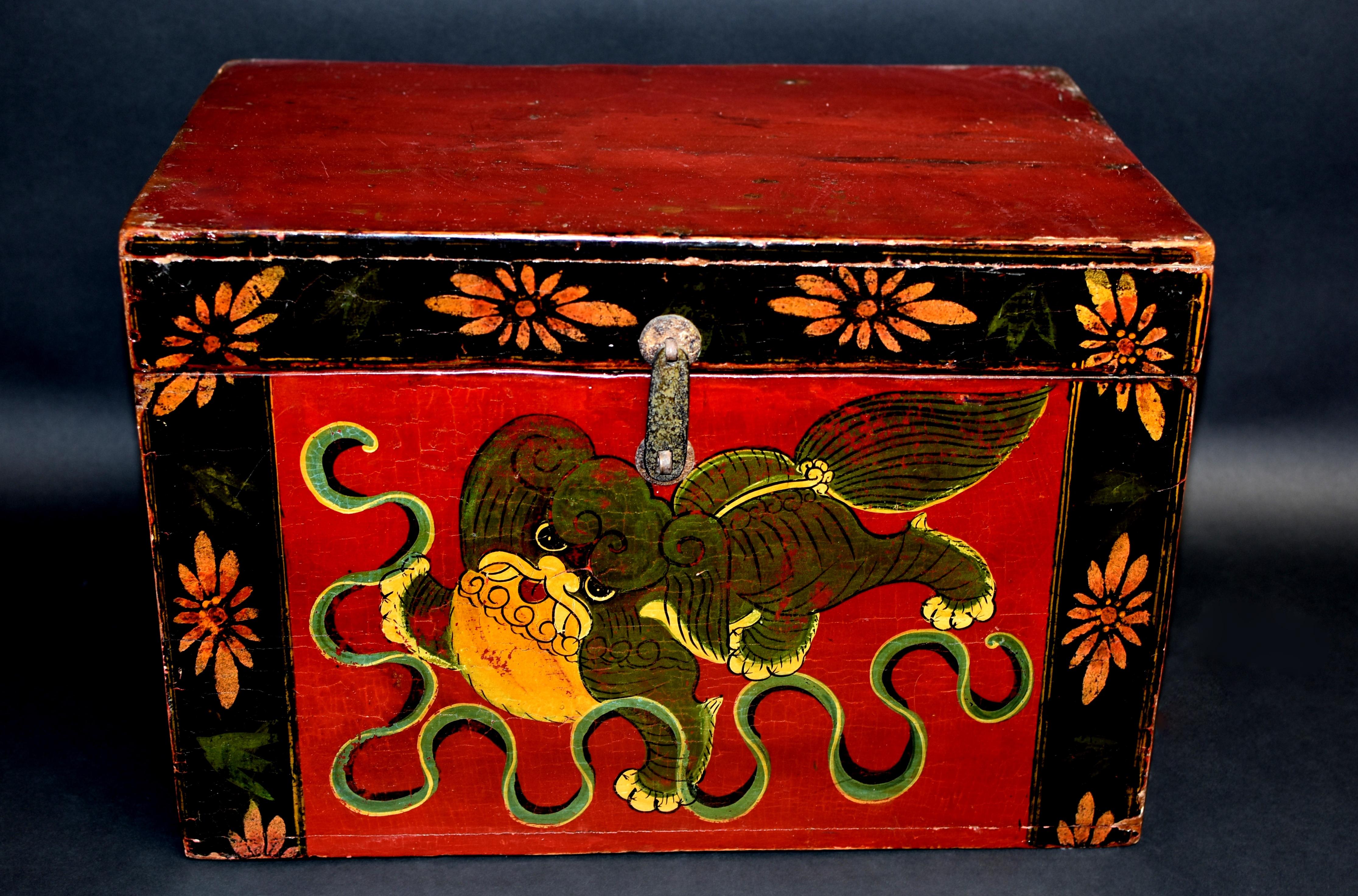 One of our most adorable foo dogs among our limited antique foo dog box collection. The large head with large innocent eyes and red lips framed by curled mane. Fleshy paws, three pressing into the ground, one open and in air trying to catch the