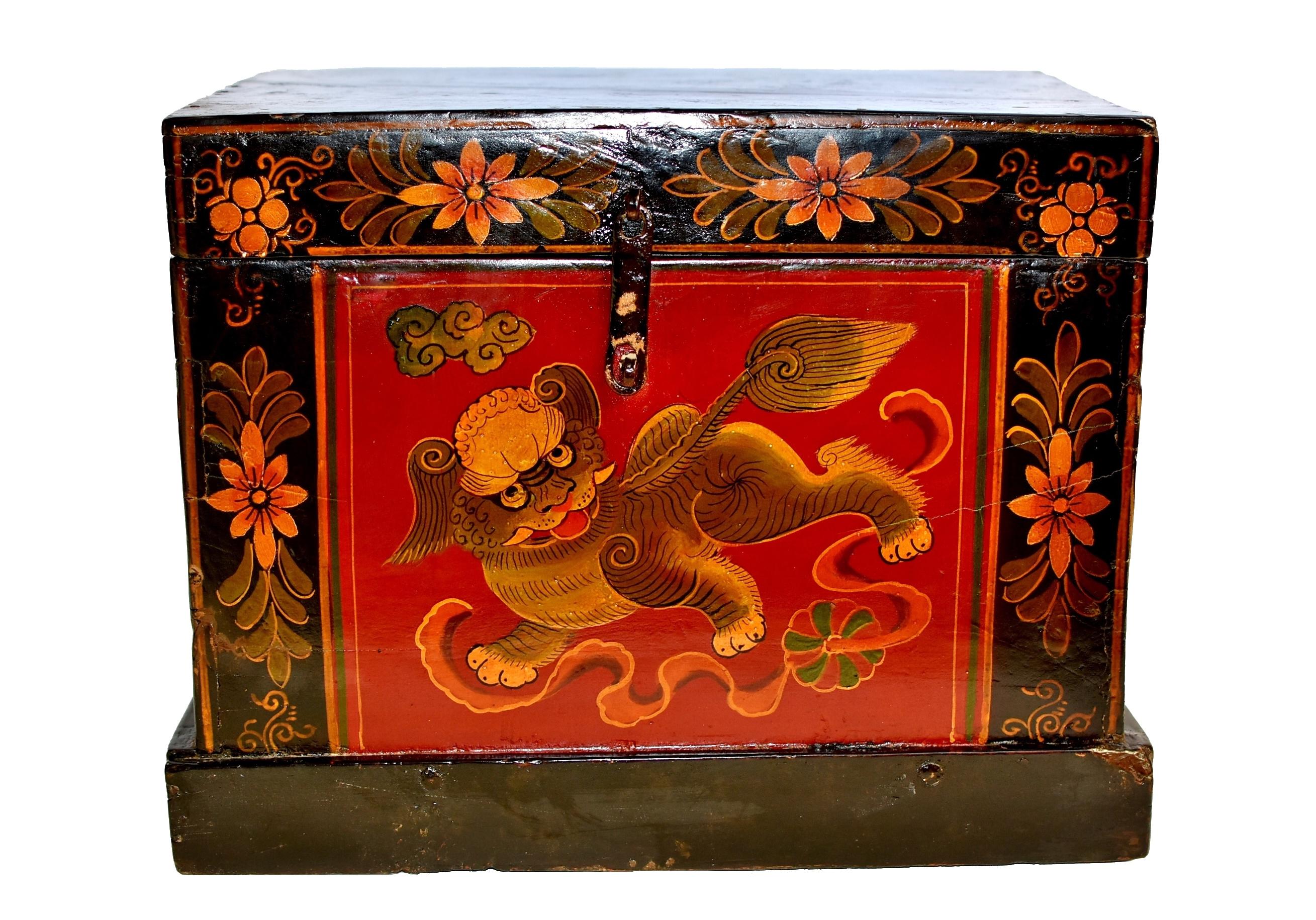 This special hand painted box has a unique base giving it a more formal look while enhancing stability. Featured foo dog with a masculine body and dramatic pear shaped tail looks back to a brocade ball stung with silk ribbons under a floating cloud.