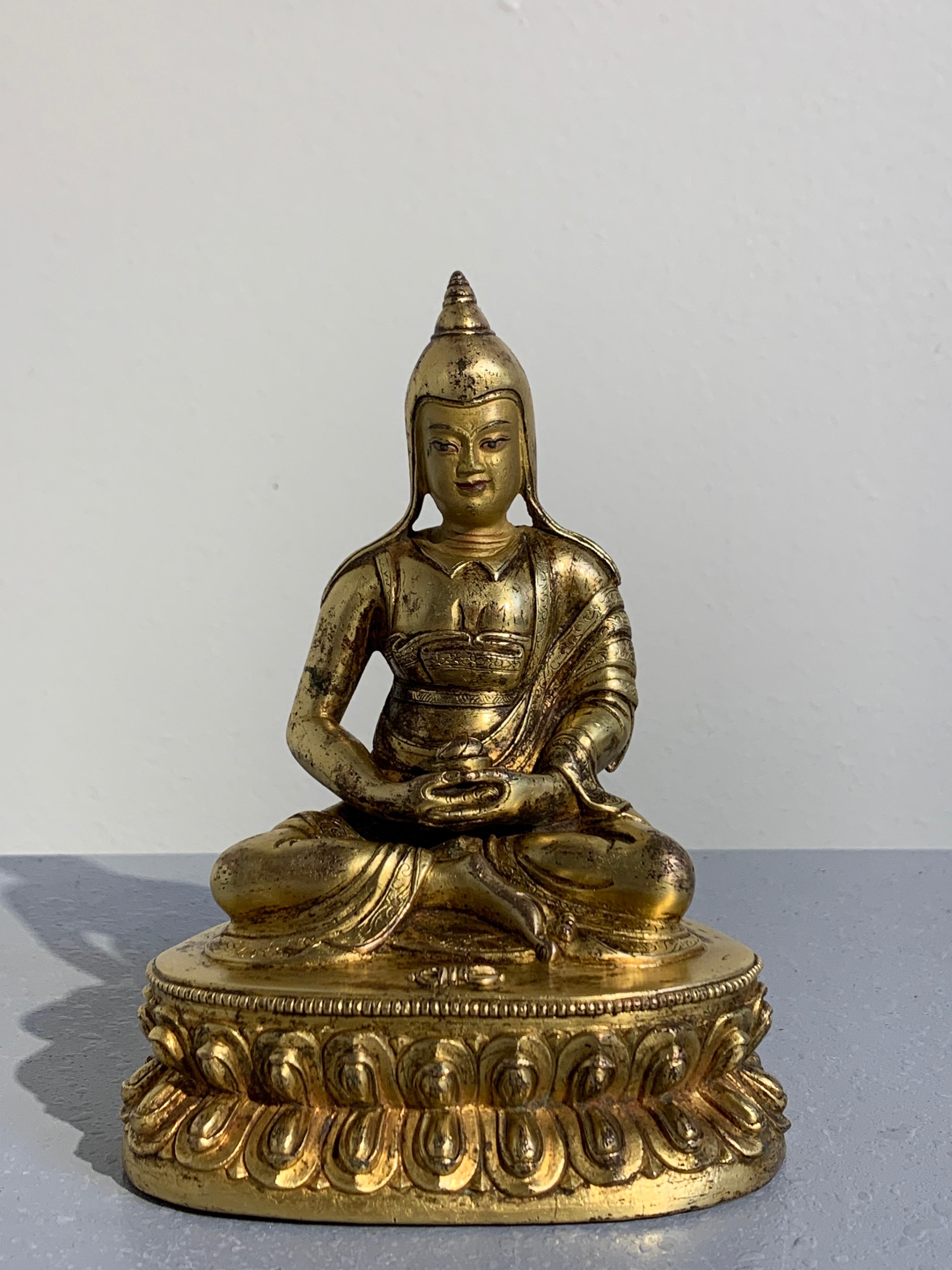 A fine and well cast 16th-17th century Tibetan gilt copper alloy statue of Shantideva, the great 8th century Indian teacher and scholar. 

The gilt bronze figure expertly cast, with wonderful detail and rich gilding. The face cold painted gold