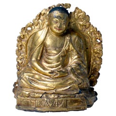 Antique Tibetan Gilt Copper Repoussé Image of a Seated Lama