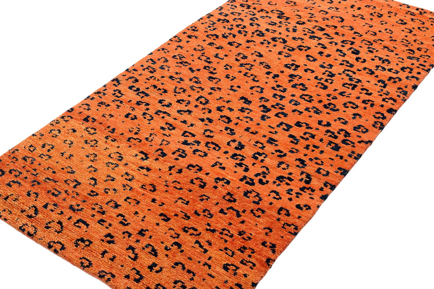 A bright orange contrasts against the strong black leopard dots in this Leopard print design. Handwoven in handspun Himalayan wool, Joseph Carini was inspired by the markings on one of the most majestic and elusive wild creatures, in a versatile 3'